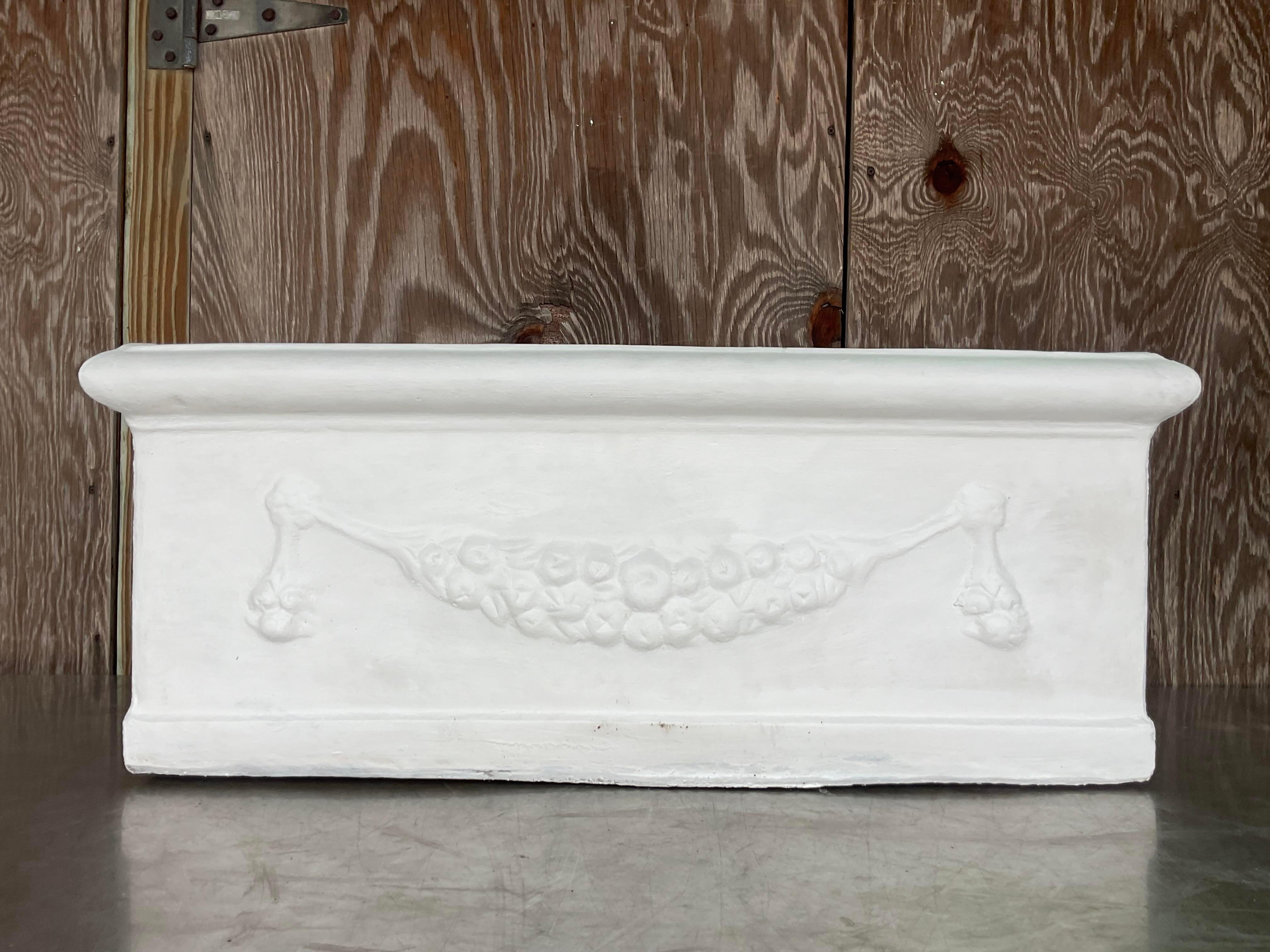 A fabulous vintage Coastal planter. A chic cast concrete with a hanging laurel motif. 16 planters available on my Chairish page. Acquired from a Delray estate.