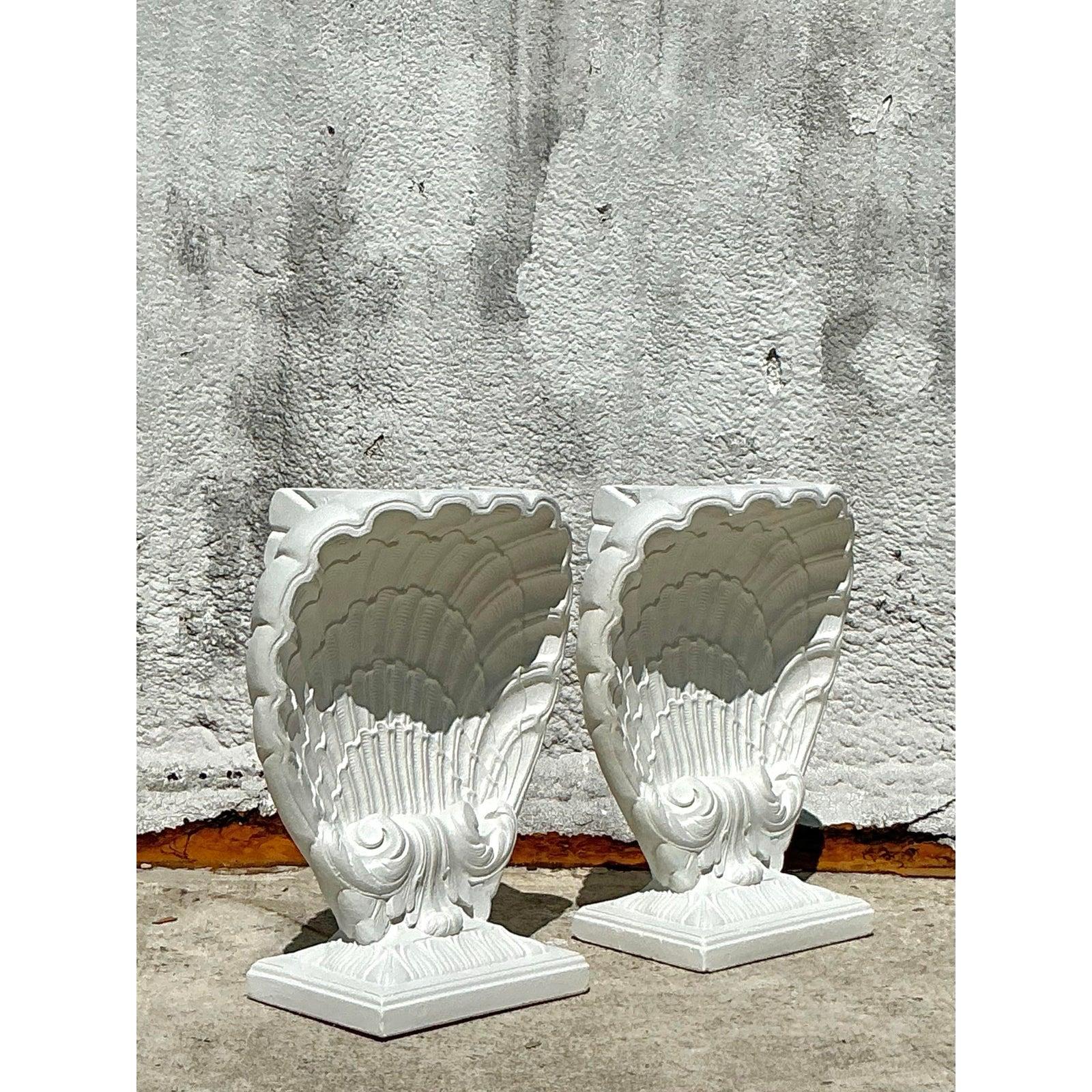 A breathtaking ode to Neoclassical and coastal design, this pair of vintage table pedestals brings a sense of Grand Tour elegance to any interior. Masterfully crafted from cast plaster, each pedestal showcases the dramatic form of an oversized clam