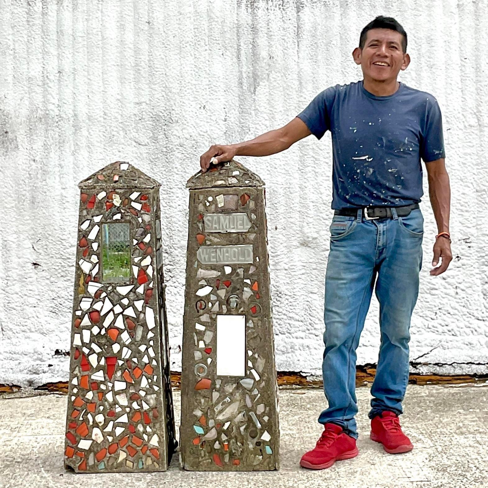 Elevate your outdoor space with this stunning pair of vintage coastal mosaic garden obelisks. Each obelisk features intricate mosaic patterns, adding a splash of color and elegance to any garden or patio. These unique, statement pieces blend