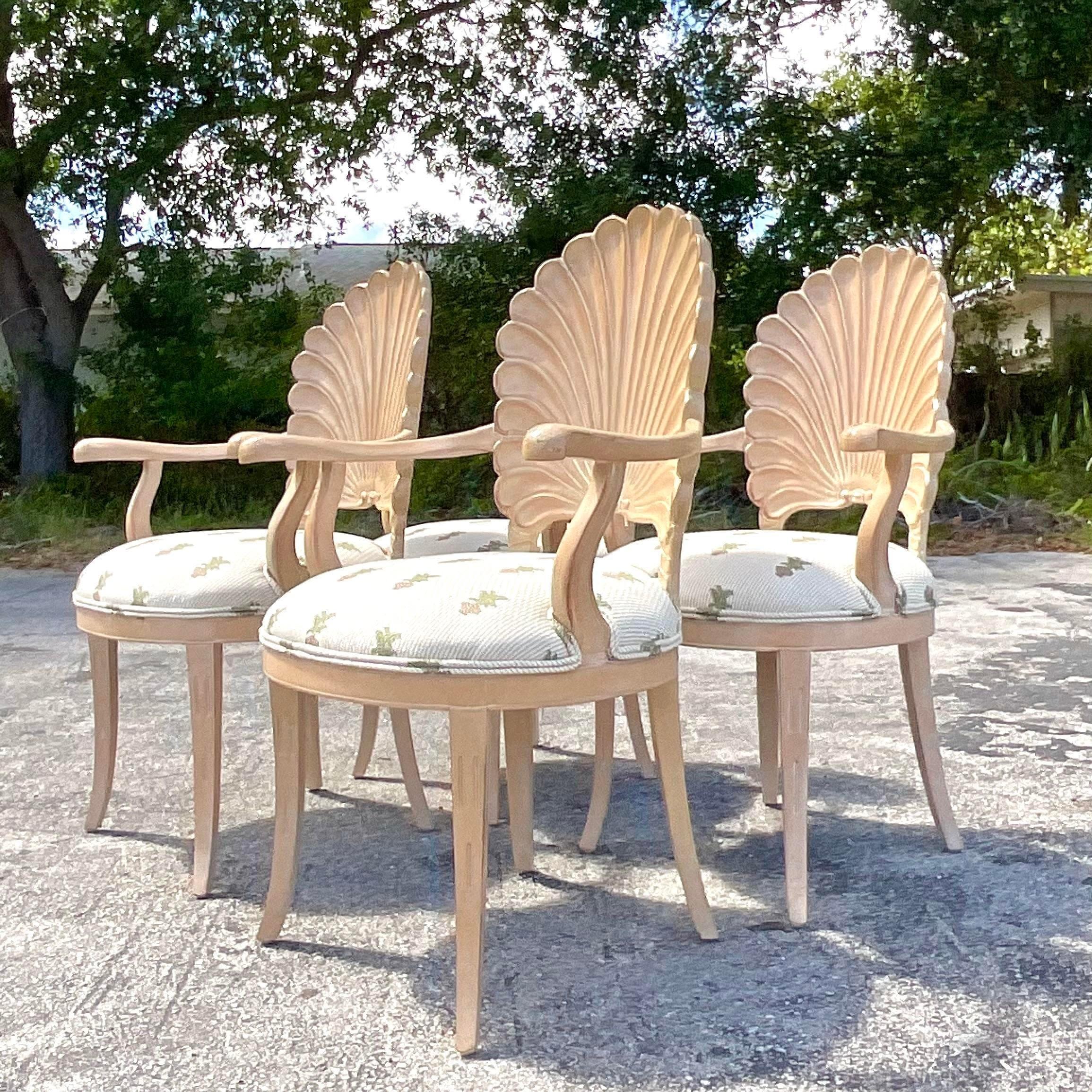 A fabulous set of vintage Coastal dining chairs. Four beautiful hand carved armchairs in a chic grotto design. Acquired from a Palm Beach estate.