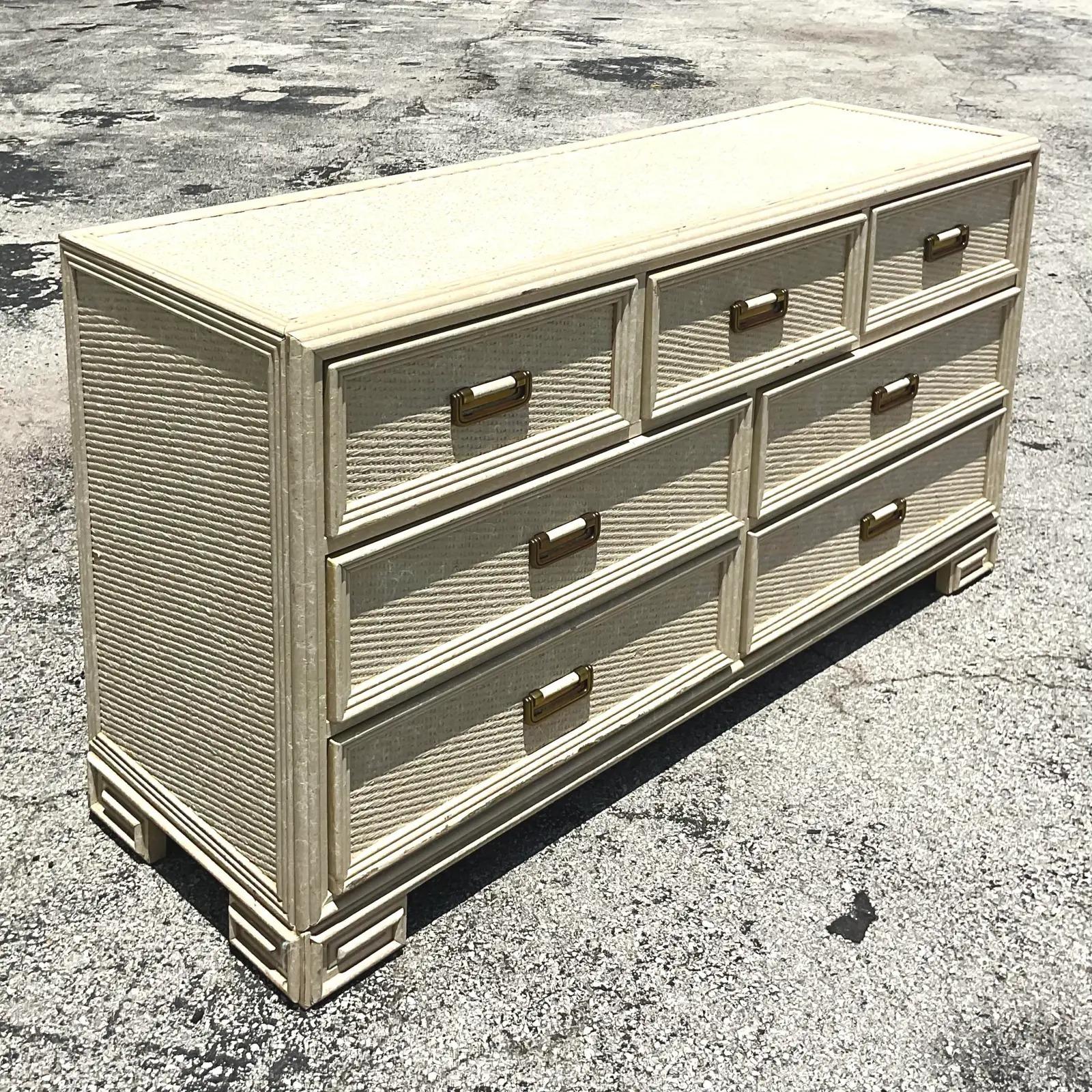 Fantastic vintage Coastal dresser. Made by the iconic Lexington group. Beautiful woven rattan with beautiful Millwork trim. Chic Greek Key detail along the bottom. Acquired from a Palm Beach estate.