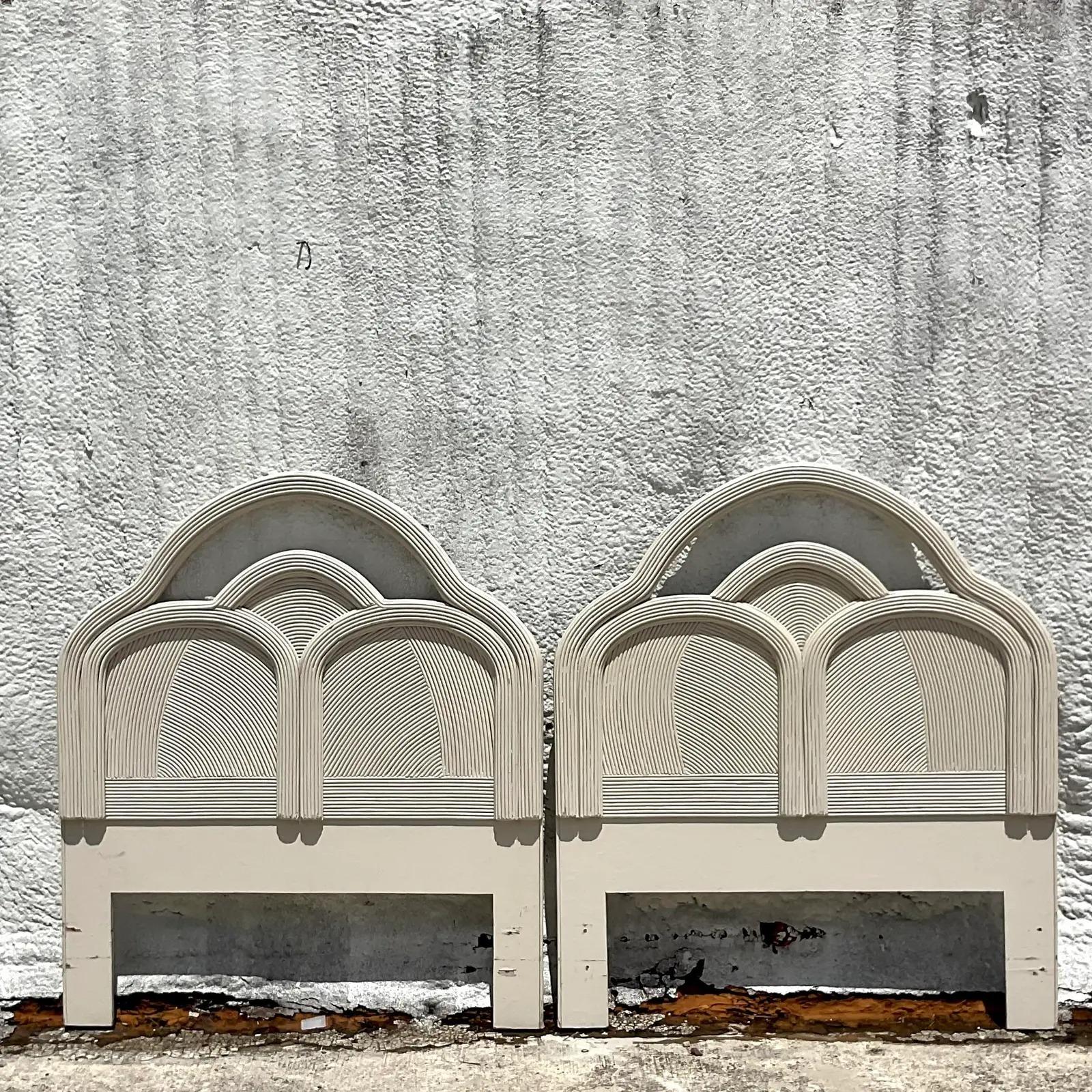 Fantastic vintage Coastal twin headboards. Beautiful pencil reed construction in a chic cerused finish. An overlapping arched design. Acquired from a Palm Beach estate.
