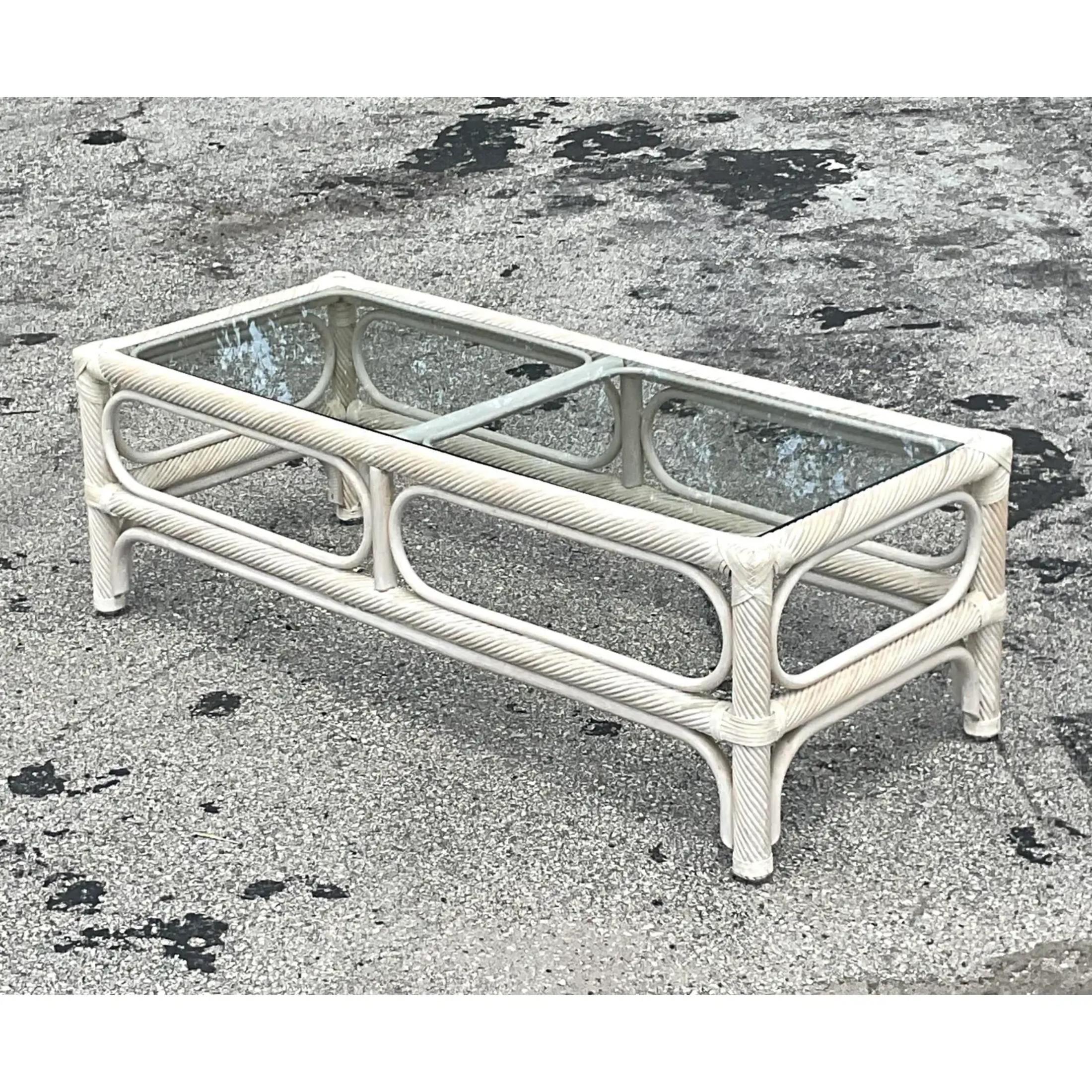 A fabulous vintage coastal coffee table. Chic twisted pencil reed design in a cerused finish inset smoked glass panel. Matching side tables also available on my Chairish page. Acquired from a Palm Beach estate