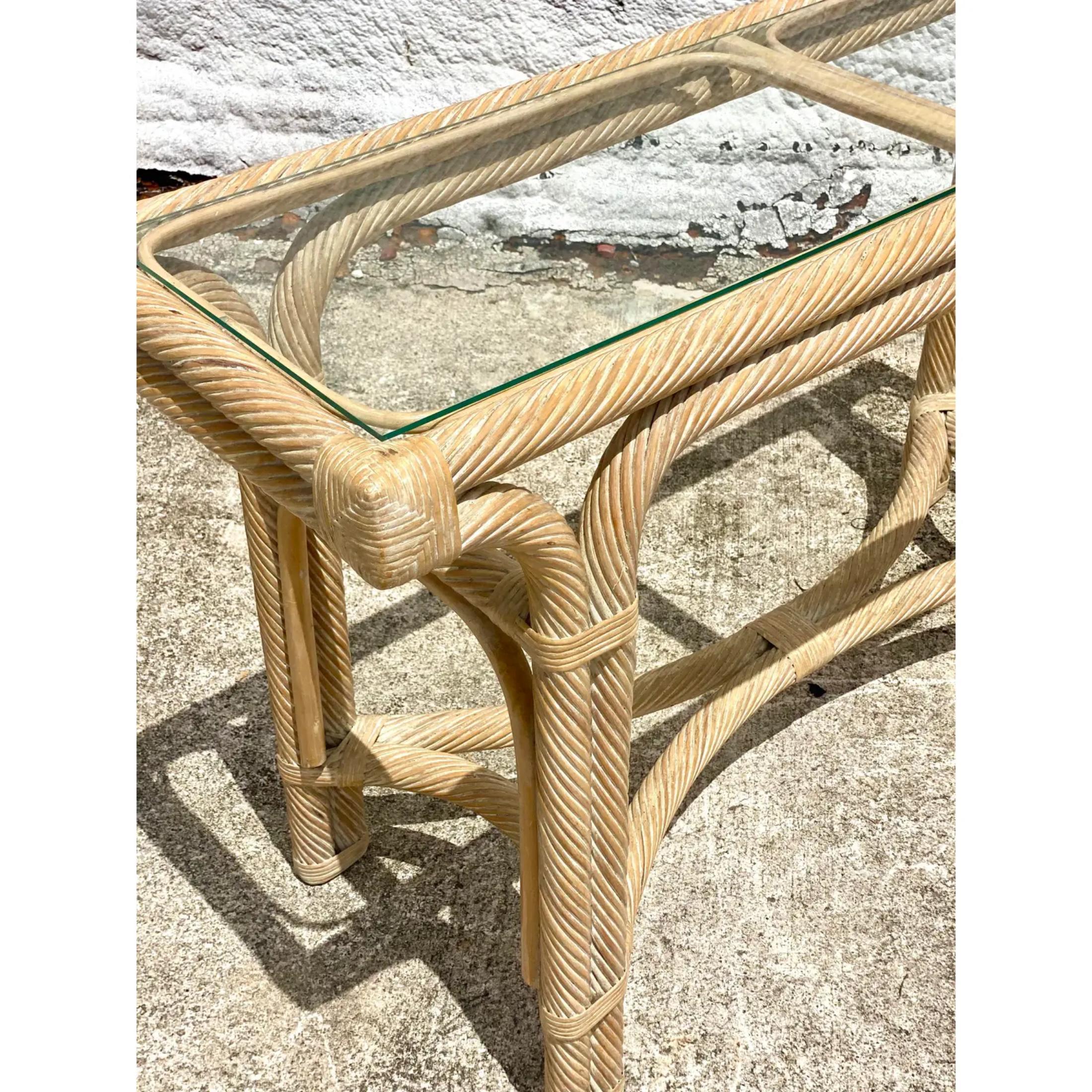 Fantastic vintage console table. Made from a cerused pencil reed in a twisted frame design. Inset glass top. Acquired from a Palm Beach estate.