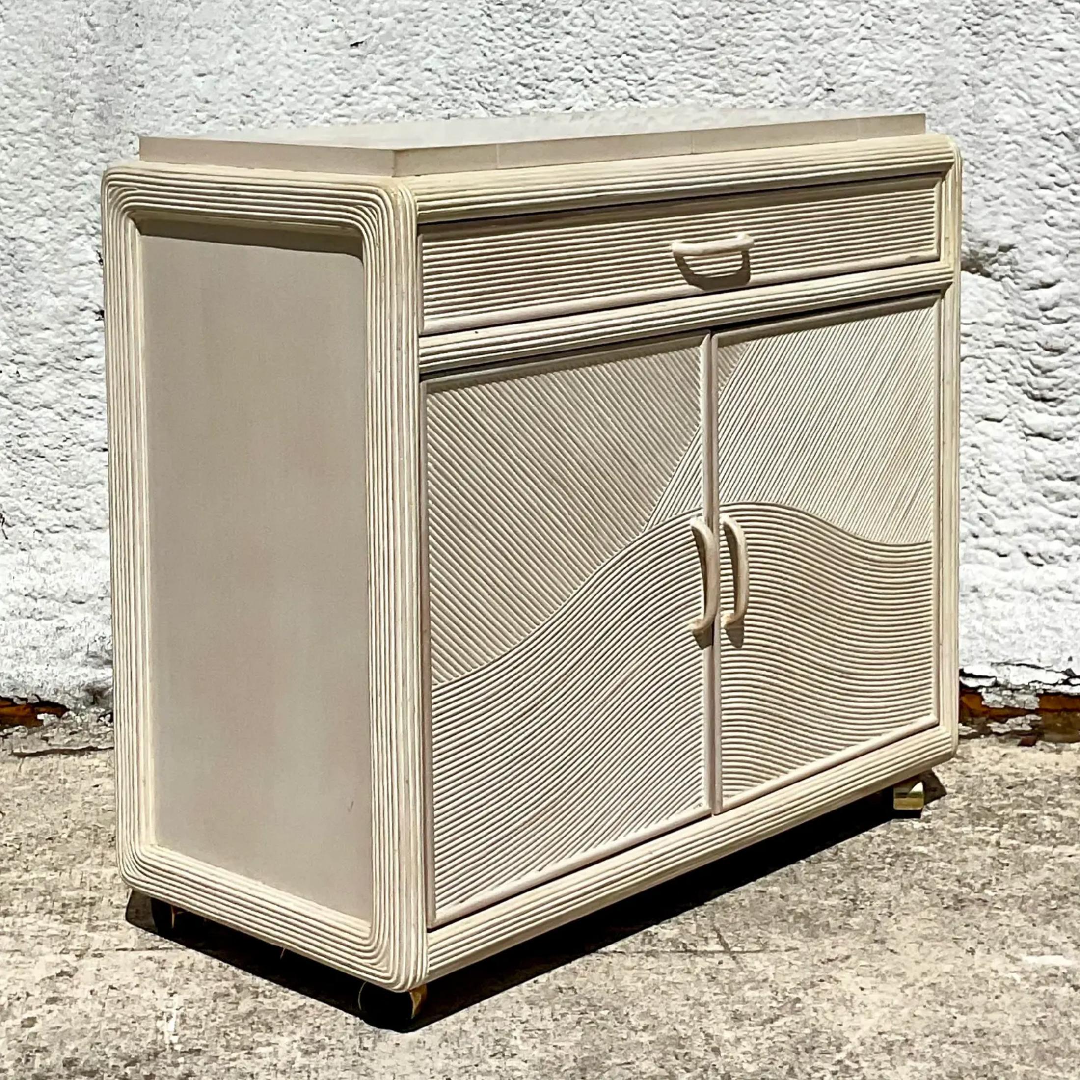 Fantastic vintage Coastal dry bar. Beautiful cerused pencil reed in a chic arched design. Lots of great storage below with a extending wings too for extra surface space. Moves around easily on casters. Perfect for indoors or outdoors in a covered