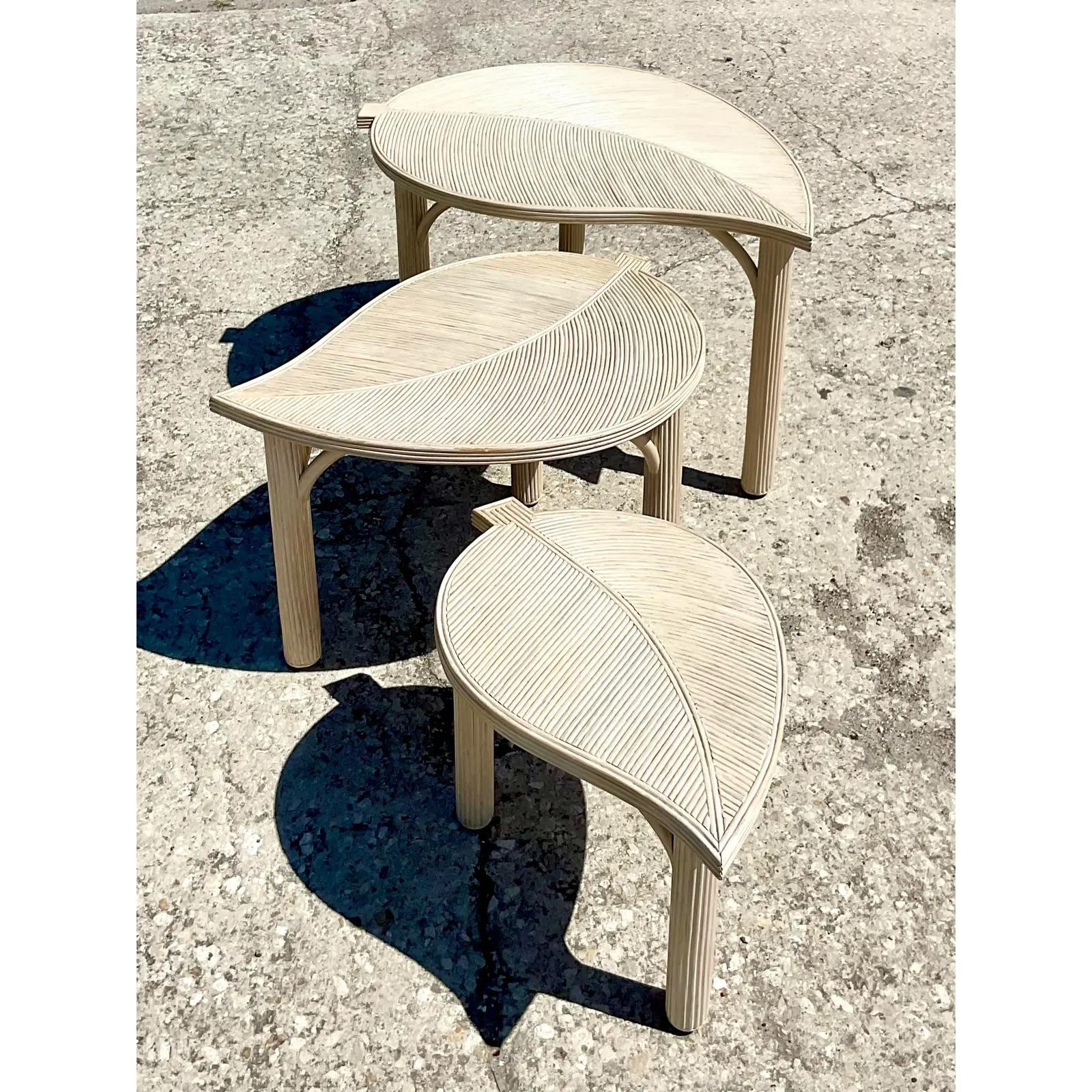 Fantastic vintage Coastal nesting tables. A set of three pencil reed leaf shape tables. Beautiful movement in a chic cerused finish. Acquired from a Palm Beach estate.