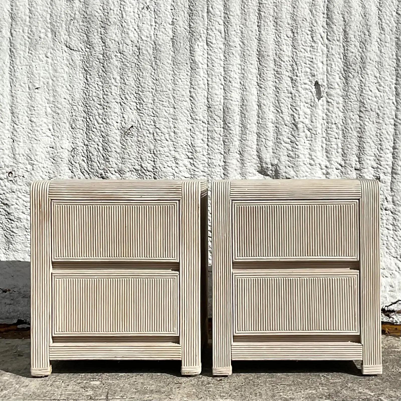 A fantastic pair of vintage Coastal nightstands. Beautiful pencil reed construction with a chic cerused finish. An excellent simple design makes these nightstands perfect for so many different styles. Acquired from a Palm Beach estate.