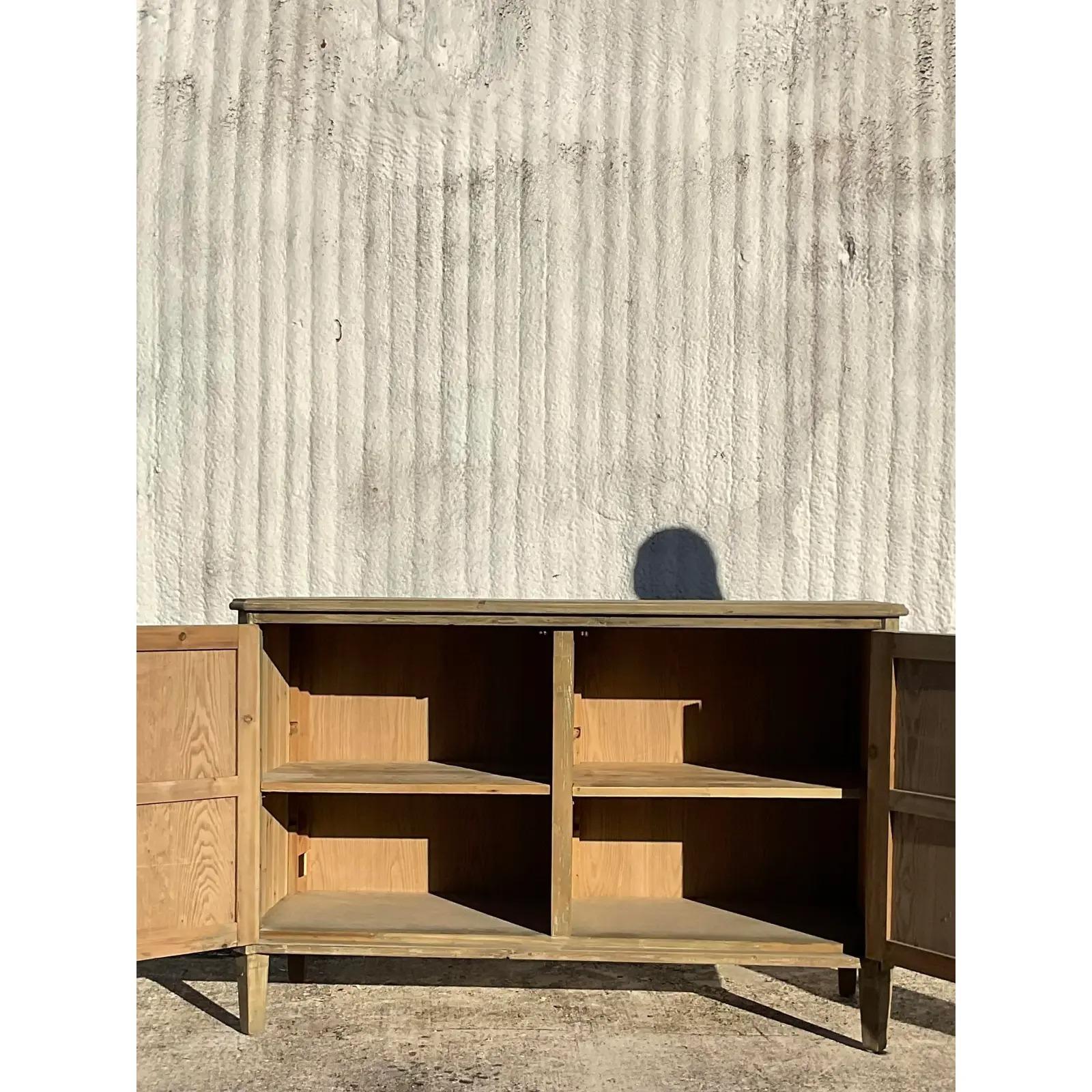 A fabulous vintage Coastal trellis credenza. A gorgeous cerused pine in a chic tall cabinet. Lots of great storage below with adjustable shelves. Acquired from a Palm Beach estate.