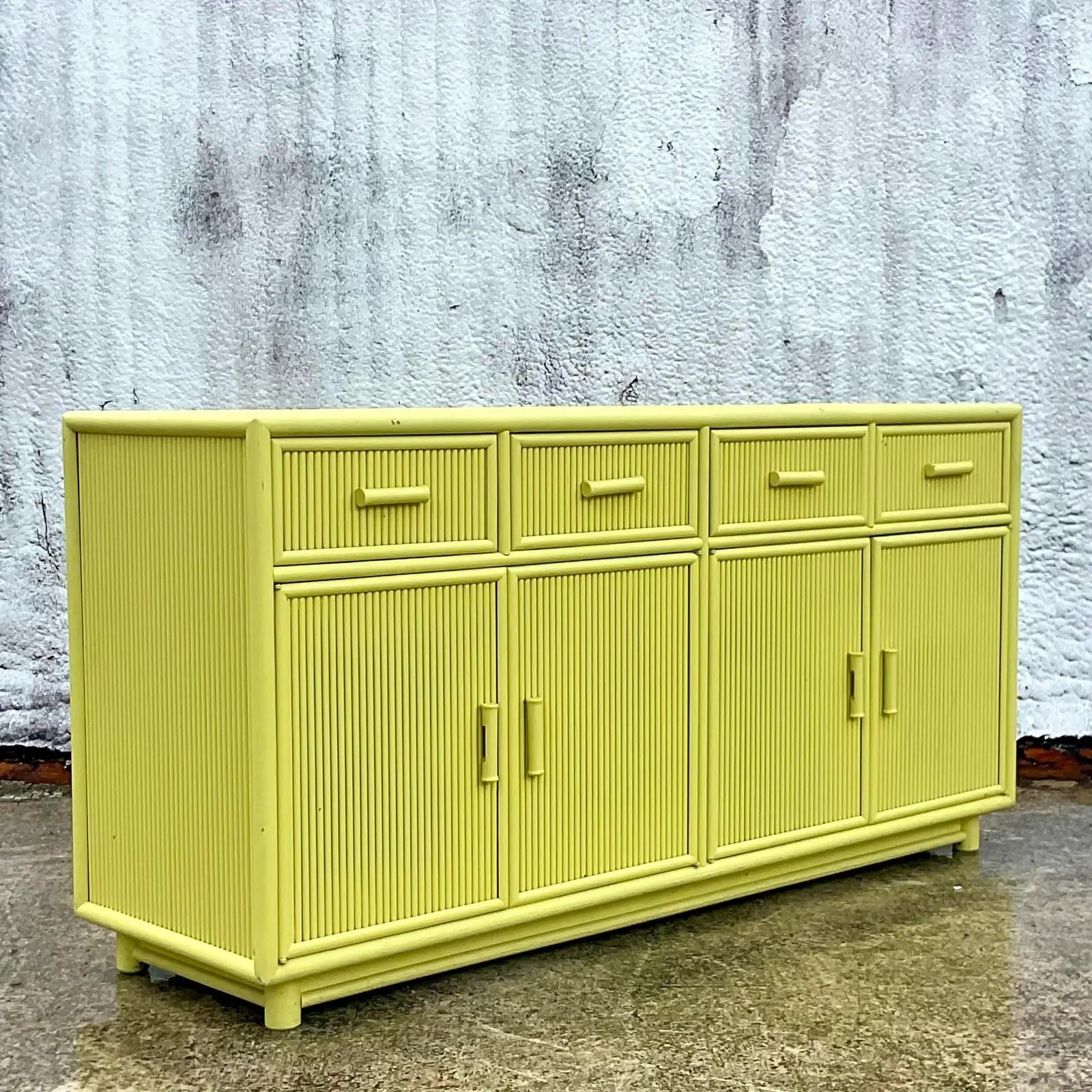 Fantastic vintage Coastal credenza. A chic rattan frame painted a brilliant Chartreuse green. Lots of great storage below. Inset glass top. Acquired from a Palm Beach estate.