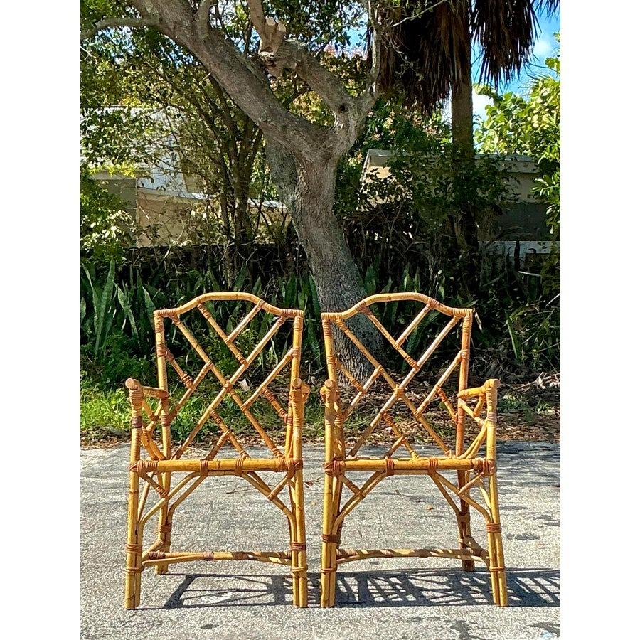 Elevate your dining space with these exquisite vintage Chinese Chippendale bamboo dining chairs. Featuring an iconic coastal-inspired design with intricate geometric patterns and handwoven detailing, these chairs blend timeless elegance with