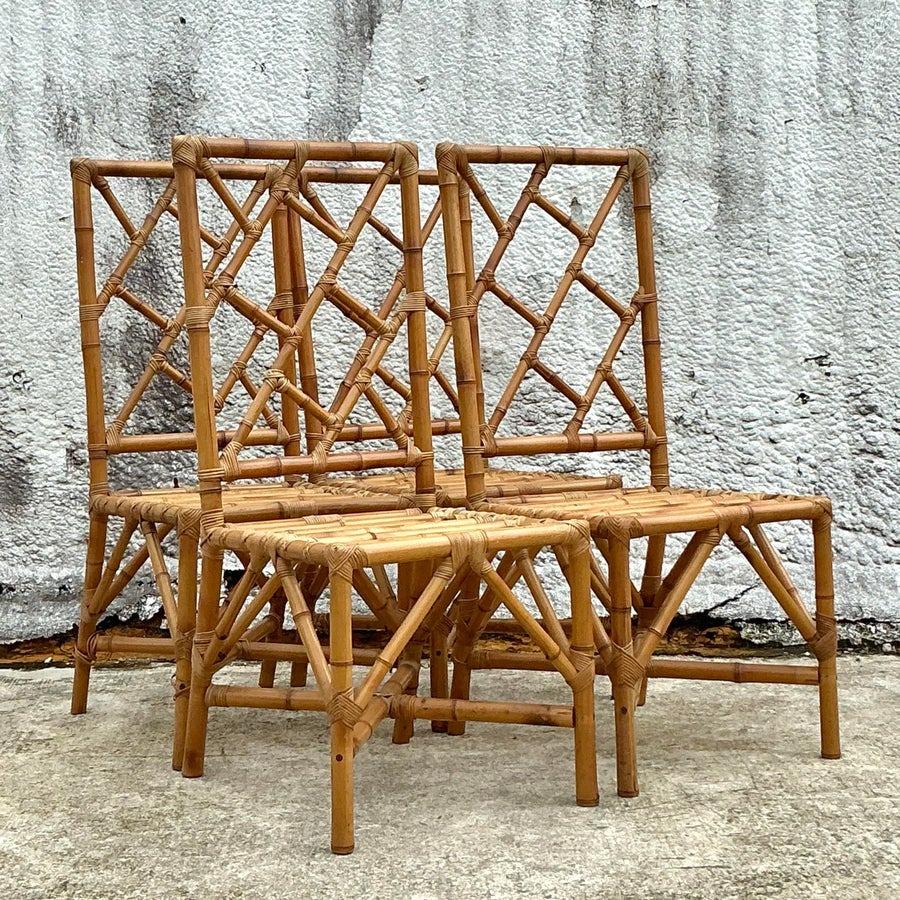 Elevate your dining space with this exquisite set of four vintage Chinese Chippendale-style dining chairs. Crafted from natural rattan, these chairs feature an intricate geometric design on the backrests, blending timeless elegance with coastal