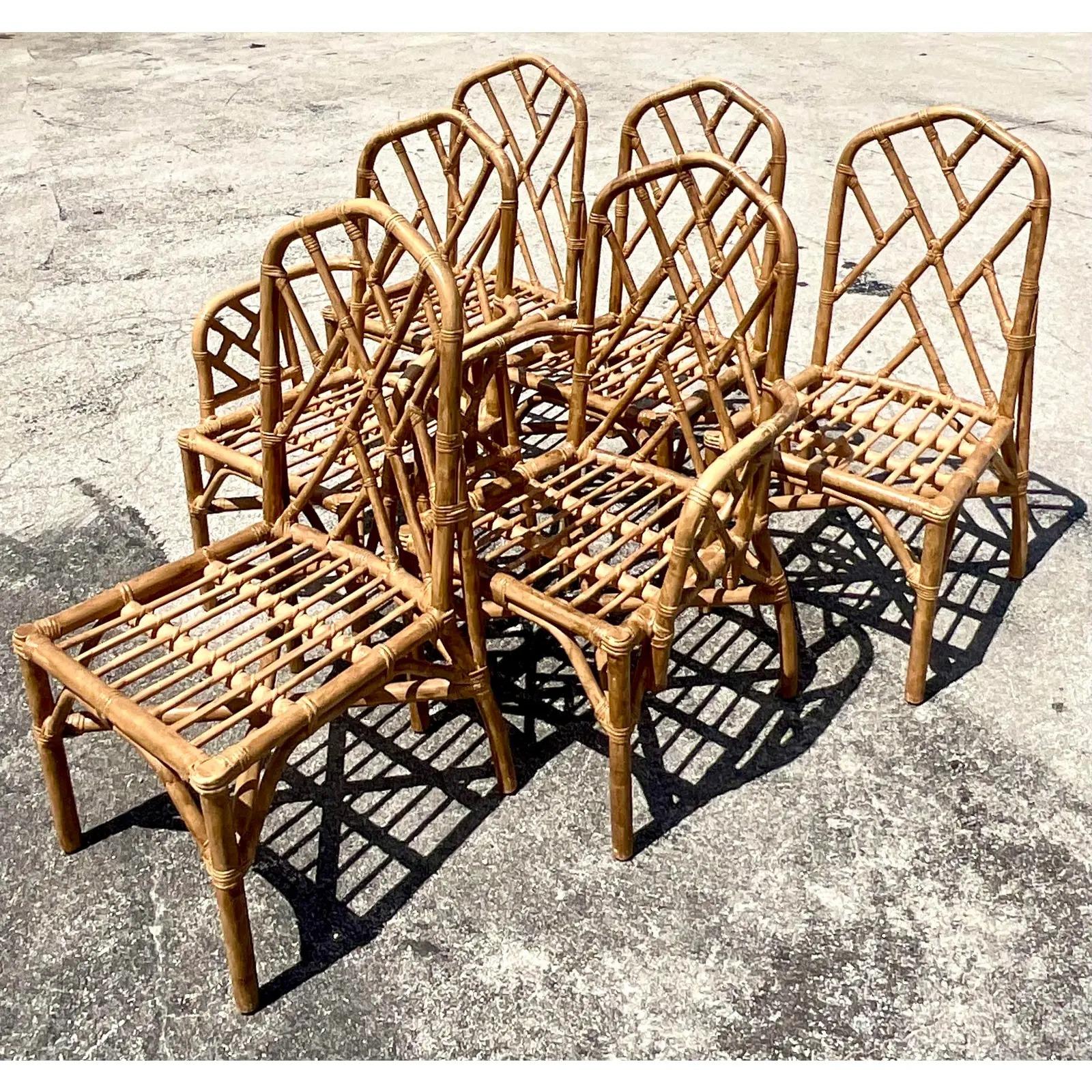 Fantastic vintage Coastal dining chairs. Beautiful bent rattan in the coveted Chinese Chippendale design. Acquired from a Palm Beach estate.