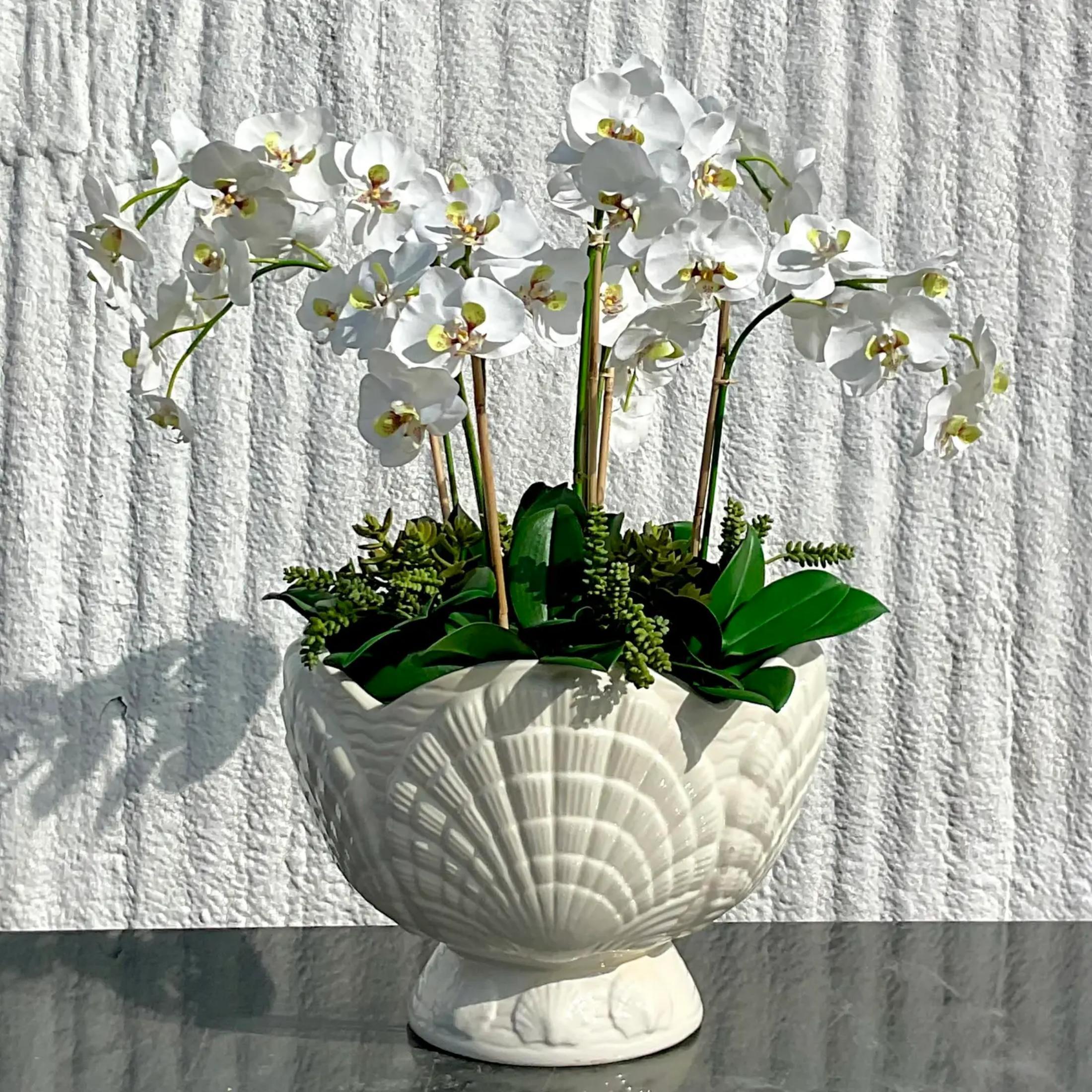 A vintage Coastal glazed ceramic cache pot. A beautiful white bowl filled with gorgeous white silk orchids. Acquired from a Naples estate.