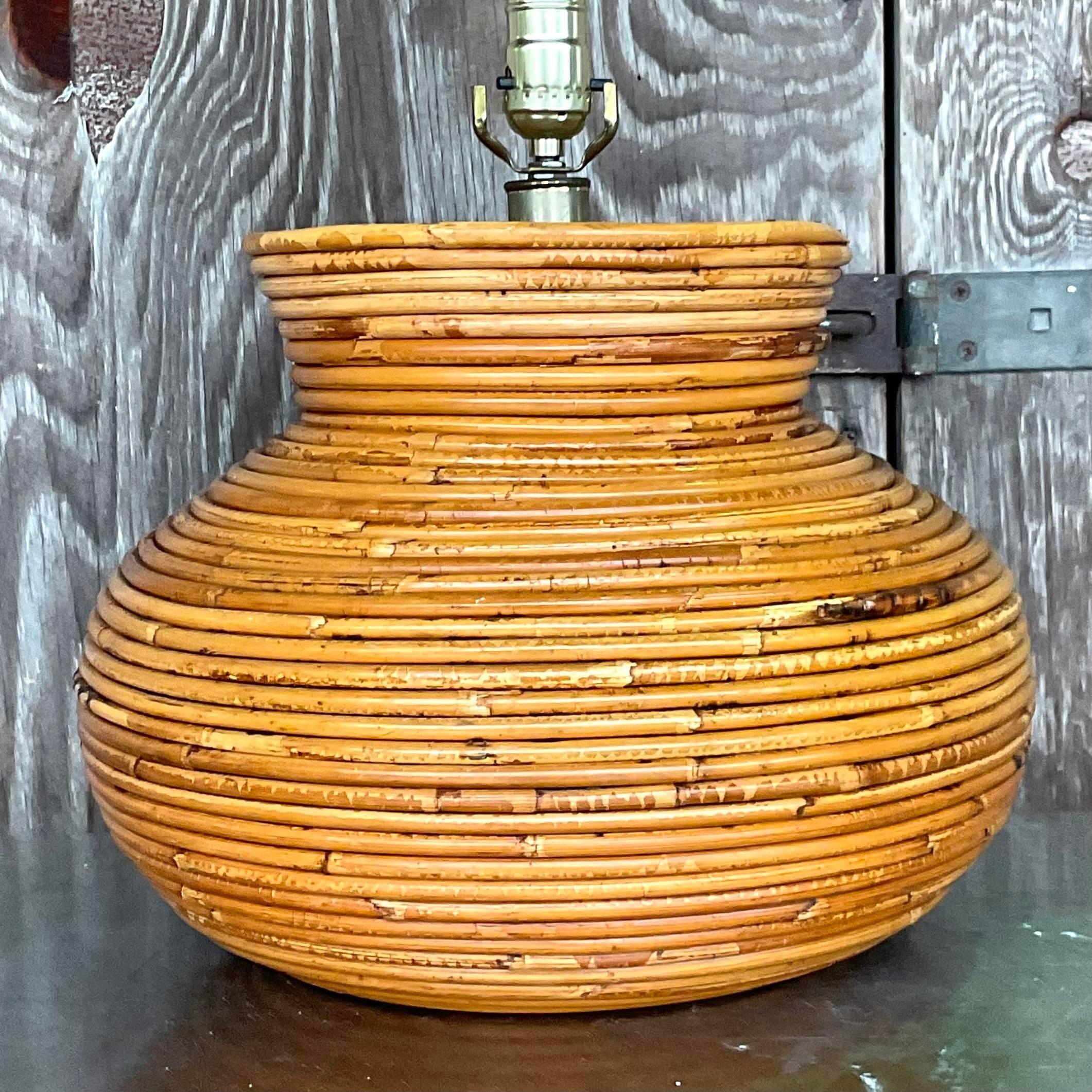 A fabulous vintage Coastal table lamp. A chic coiled pencil reed in a clean and modern shape. Acquired from a Palm Beach estate
