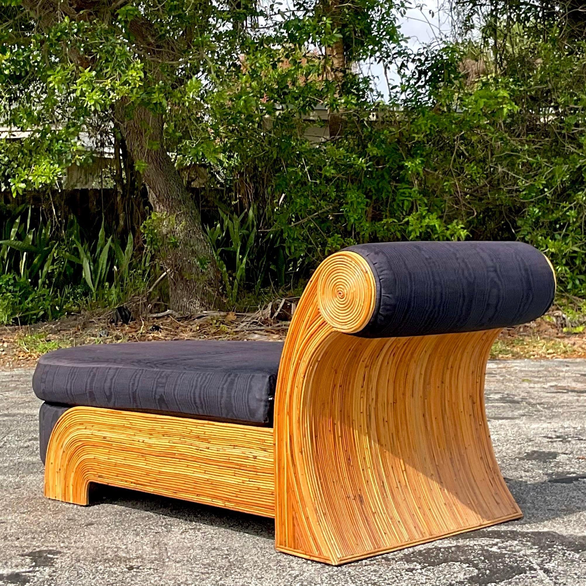 A fantastic vintage Coastal chaise lounge. Made by the iconic Comfort Designs and tagged on the bottom. A chic pencil reed frame in a fab scroll design. Acquired from a Palm Beach estate.