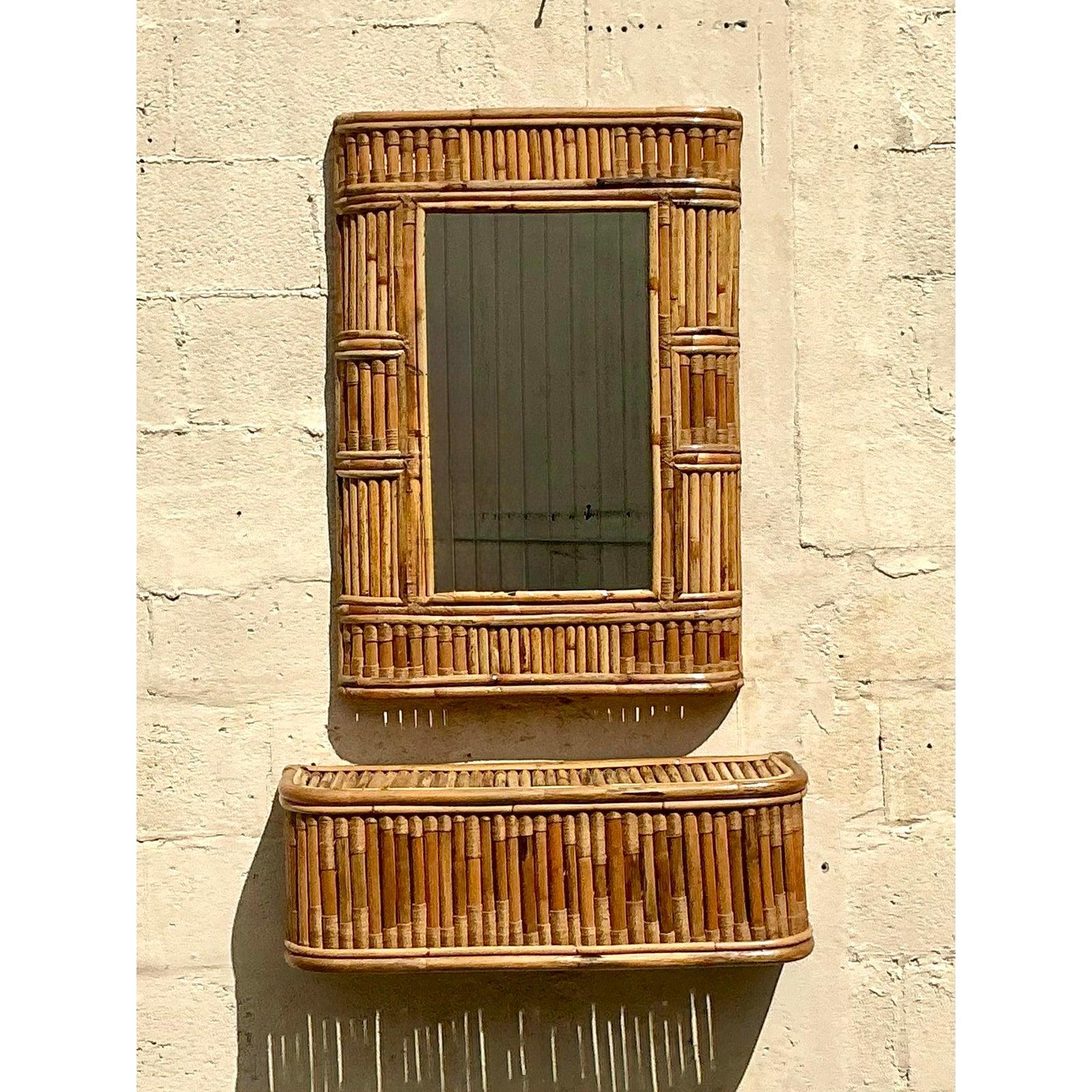 Elevate your space with this stunning vintage coastal console mirror and table set, expertly crafted with intricate woven rattan details. The mirror features a beautifully framed bamboo design, adding a natural, organic aesthetic, while the matching