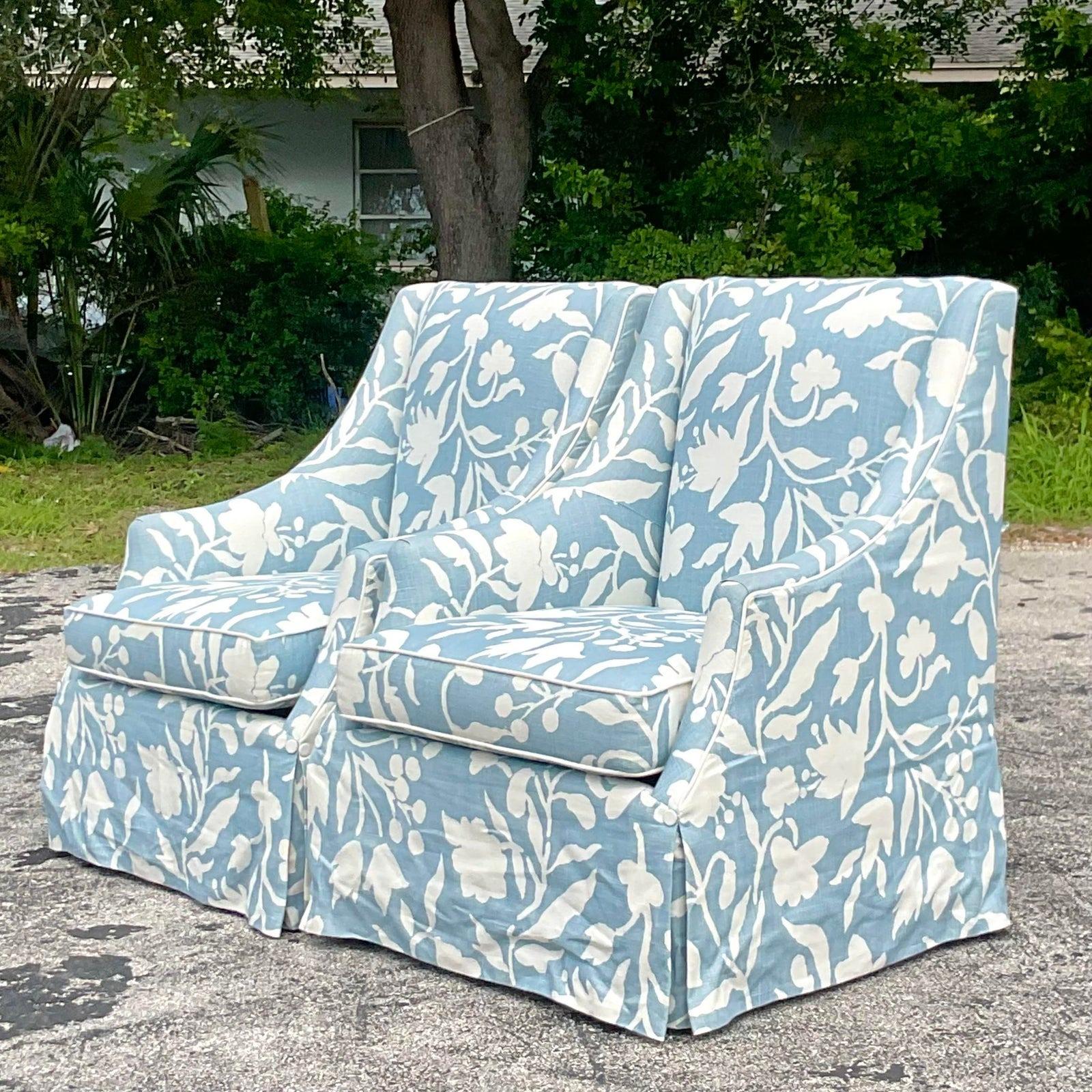 A gorgeous vintage pair of Coastal lounge chairs. Made by the Cooper Brothers group. A chic printed floral in a pale blue and white. Acquired from a Palm Beach estate.