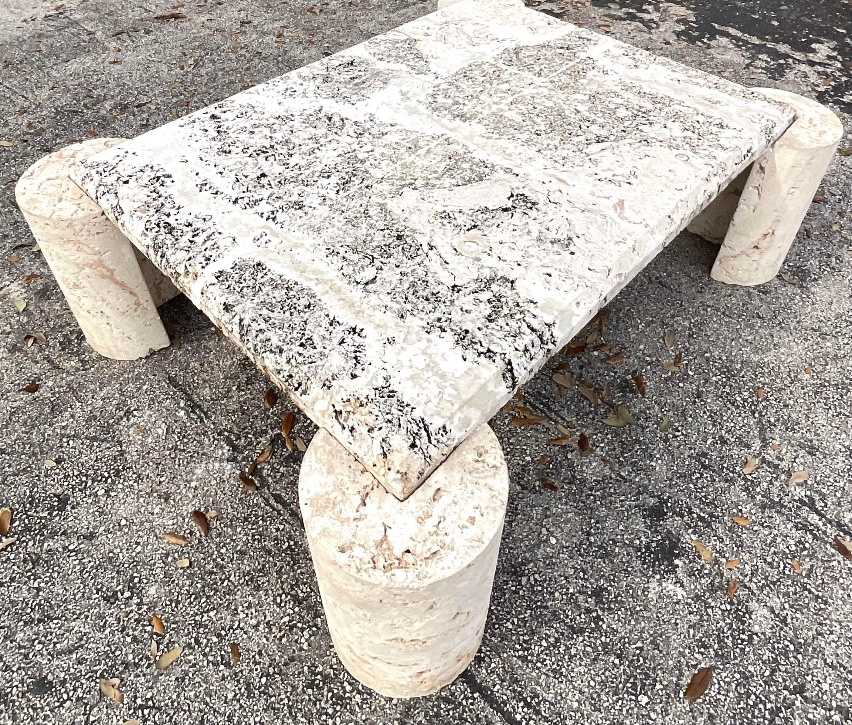A fantastic vintage Coastal Coffee table. Four free standing coquina stone cylinders support a beveled coquina slab. Acquired from a Palm Beach estate.