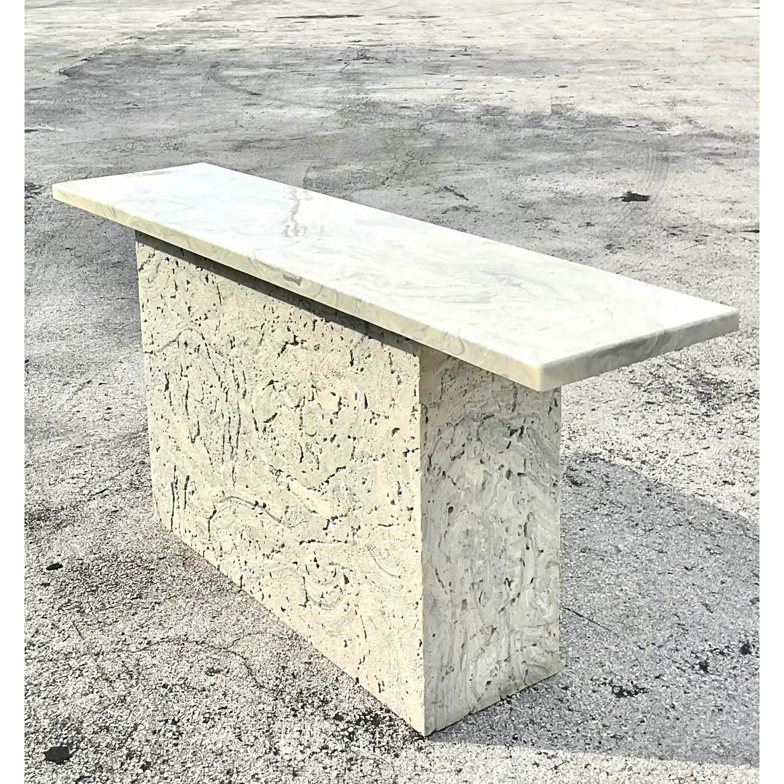Fantastic vintage Coastal console table. Beautiful coquina stone base with a faux stone top. Acquired from a Palm Beach estate.