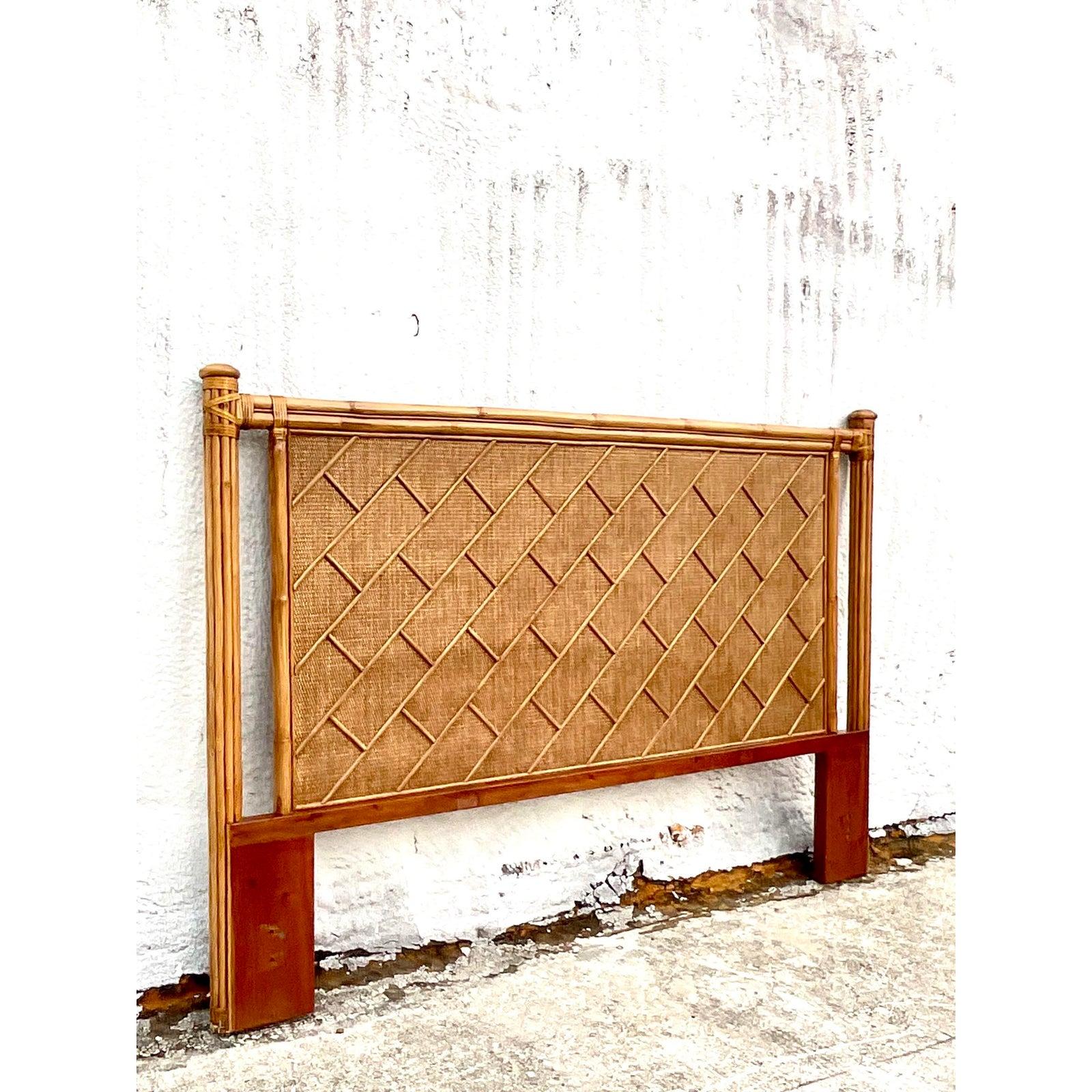 Fantastic vintage coastal King headboard. Beautiful crosshatch bamboo on an inset woven rattan panel. Bundled reed columns. Acquired from a Palm Beach estate.