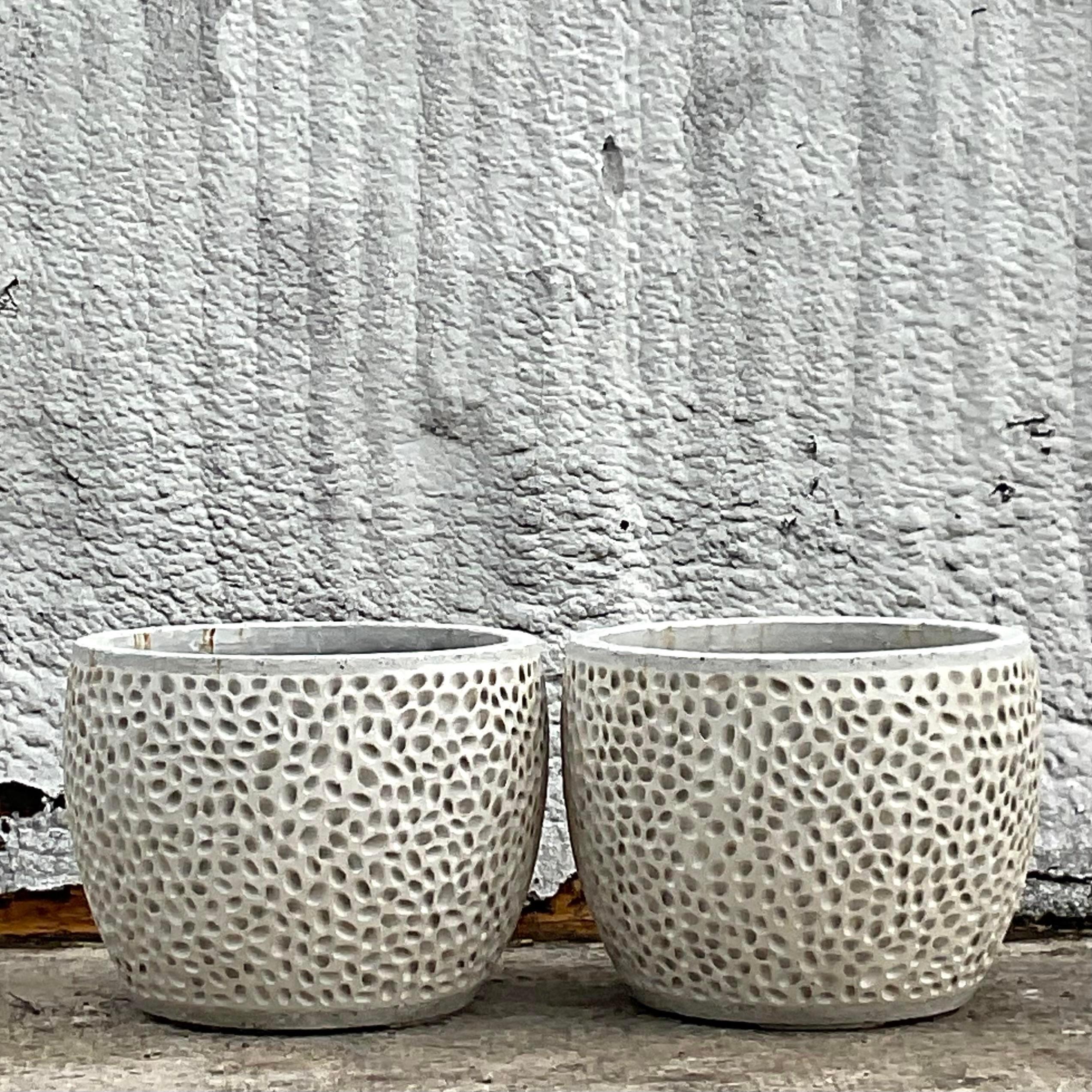 A fabulous pair of vintage Coastal planters. A cast concrete with a chic dimpled design. A clean and modern design. Acquired from a Palm Beach estate.