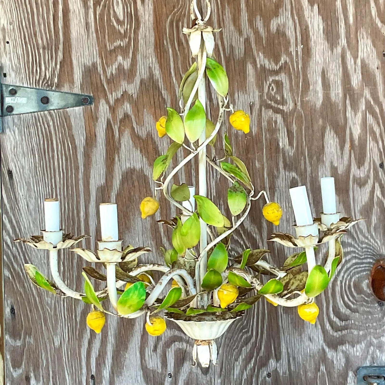 Fabulous vintage Coastal distressed chandelier. A throwback from the glory days of Palm Beach. An incredible lemon Tole style with the most charming display of leaves and lemons. It’s have an all over patina from time. I think it looks perfect, but
