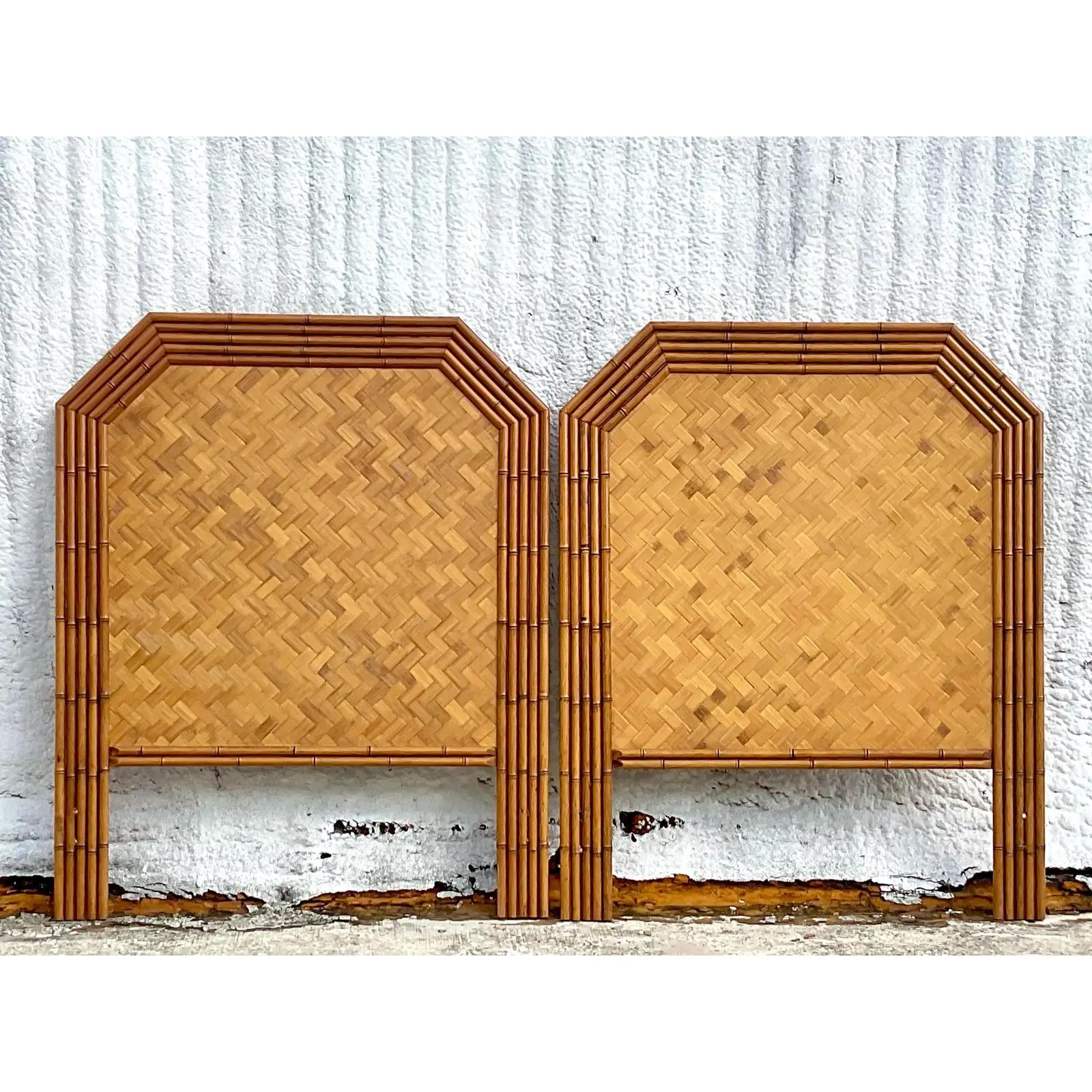 A fantastic pair of vintage Coastal twin headboard. A beautiful faceted design frame with parquet rattan inset panels. Acquired from a Palm Beach estate.