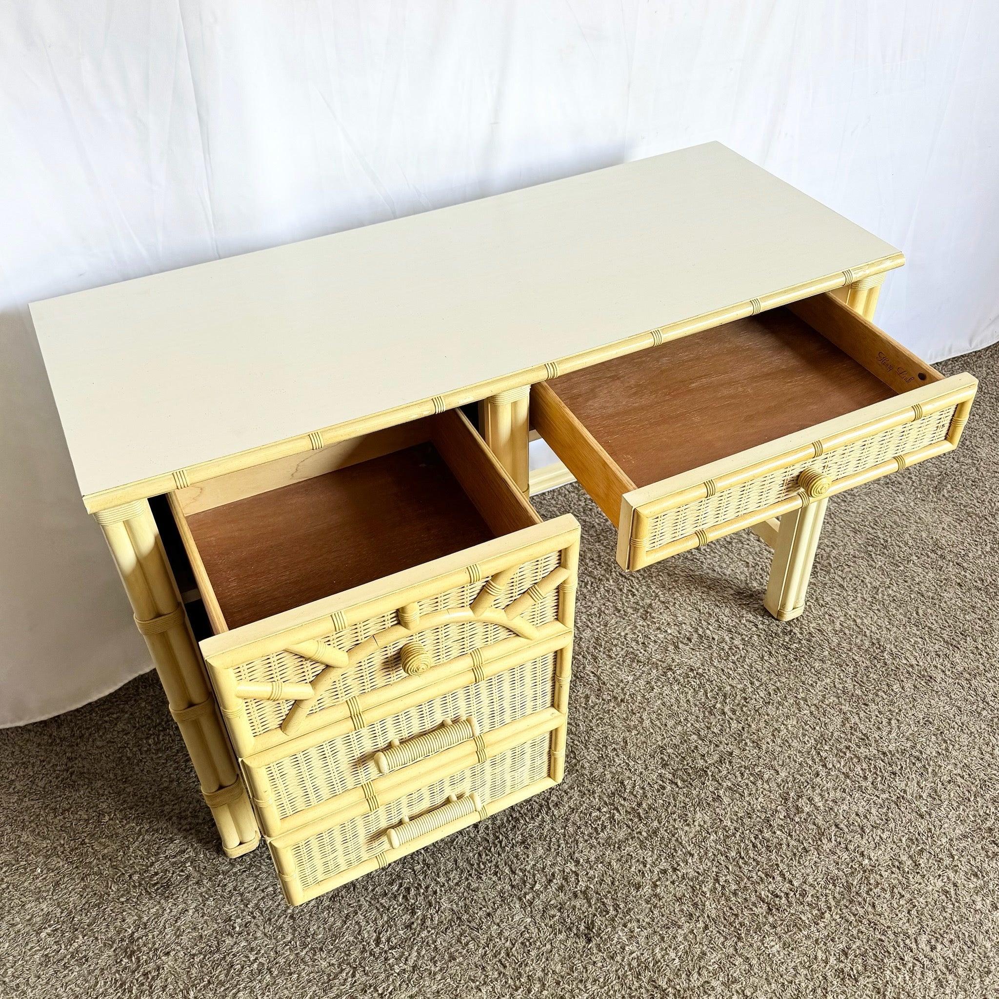 Vintage Coastal Faux Bamboo Wicker Desk with glass top, woven wicker panels, and faux bamboo trim—charming tropical workspace for elegant interiors.
 

 Wear around the edges a to the wicker a bit as shown in the photos. 
 

 We sell items as