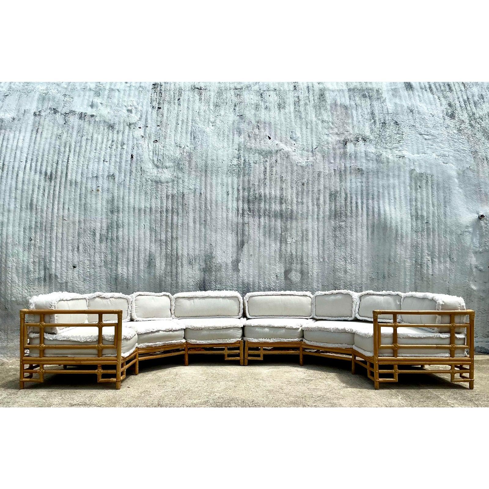 Elevate your space with this stunning vintage Ficks Reed rattan sectional, a true gem of coastal design and timeless craftsmanship. Featuring a gracefully curved silhouette and robust rattan frame, this modular sectional offers a laid-back yet