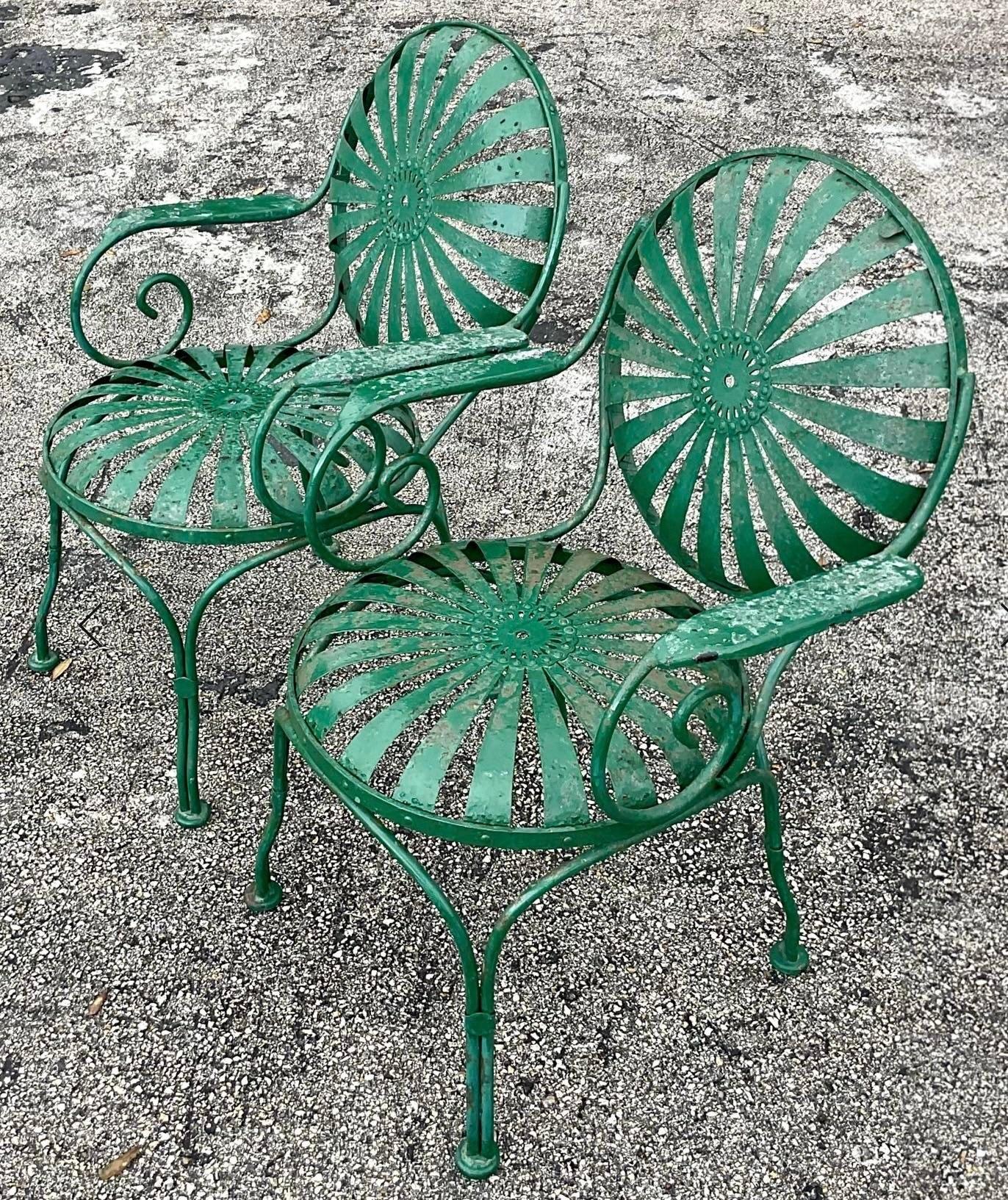 Transform your outdoor space with this set of six vintage Coastal Francois Carre sunburst wrought iron chairs, exuding timeless American style and craftsmanship. Perfect for soaking up the sun in comfort and elegance.