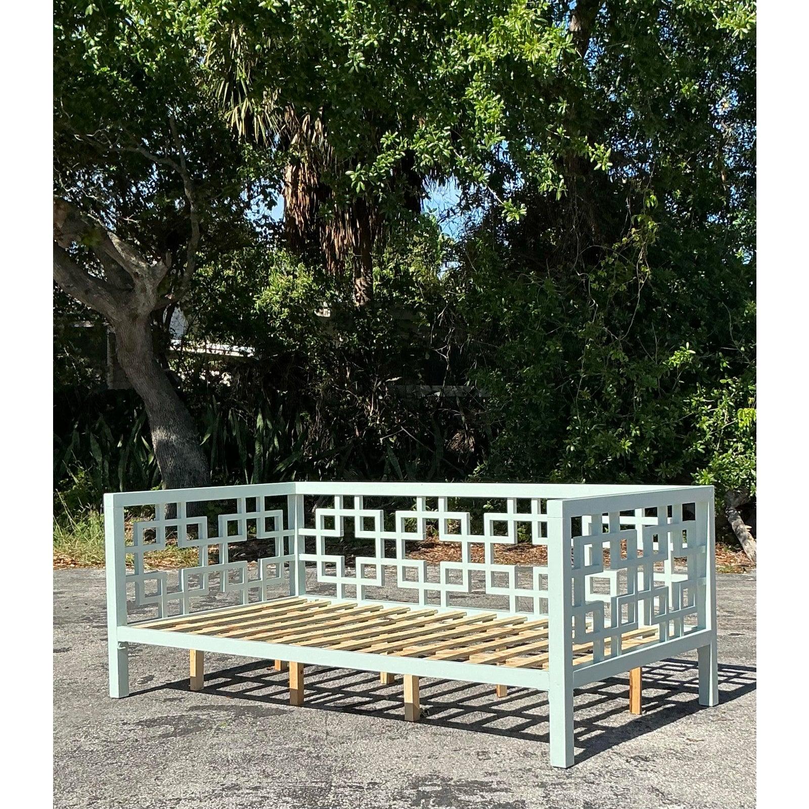 Elevate your living space with this exquisite vintage coastal fretwork daybed, a timeless blend of classic craftsmanship and modern coastal charm. Featuring an intricate geometric lattice design on its back and sides, this piece exudes a breezy,