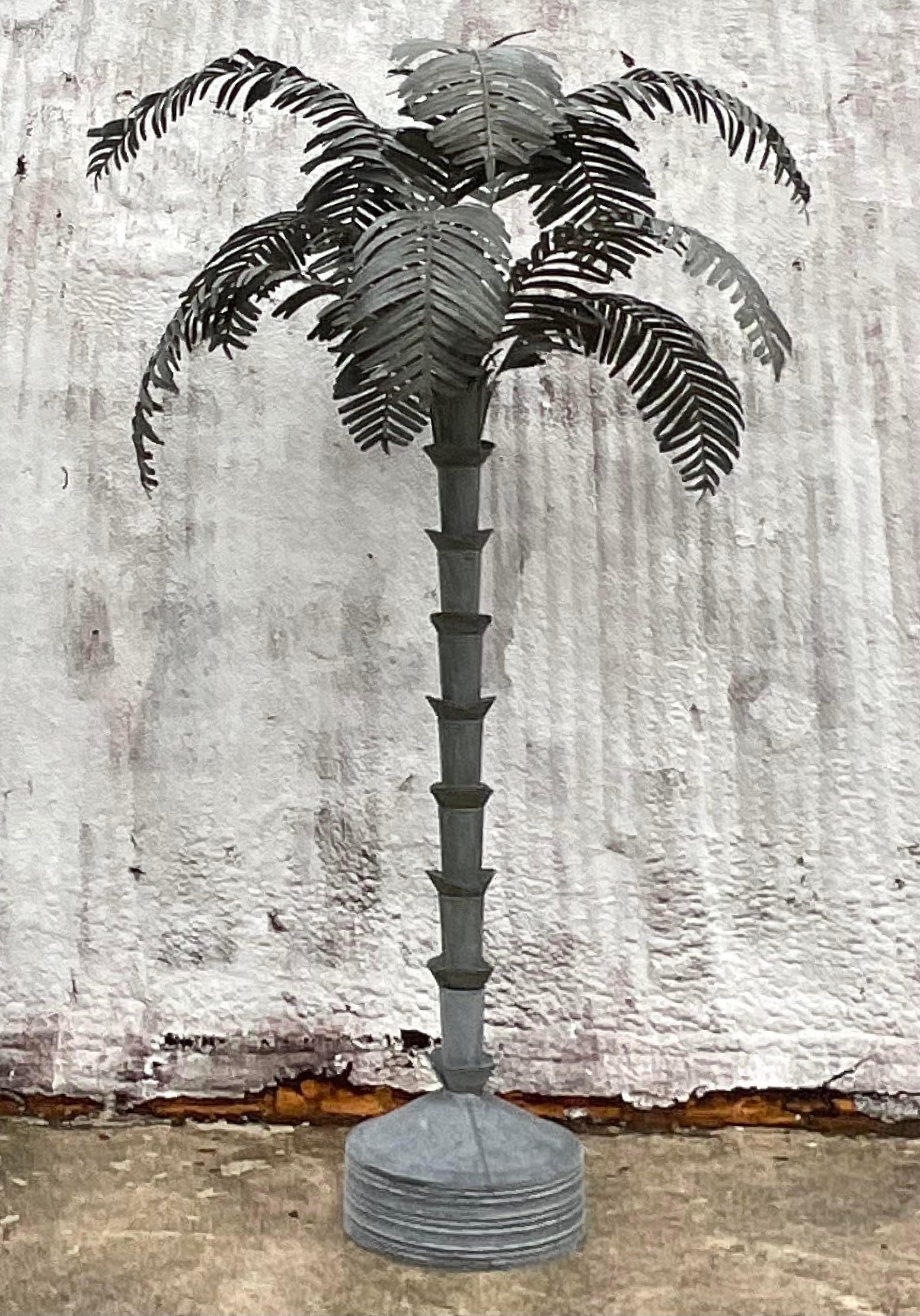 A totally incredible vintage monumental palm tree. A chic galvanized tin construction with loose palm fronds that can be arranged as you like. Acquired from a Hobe Sound estate.