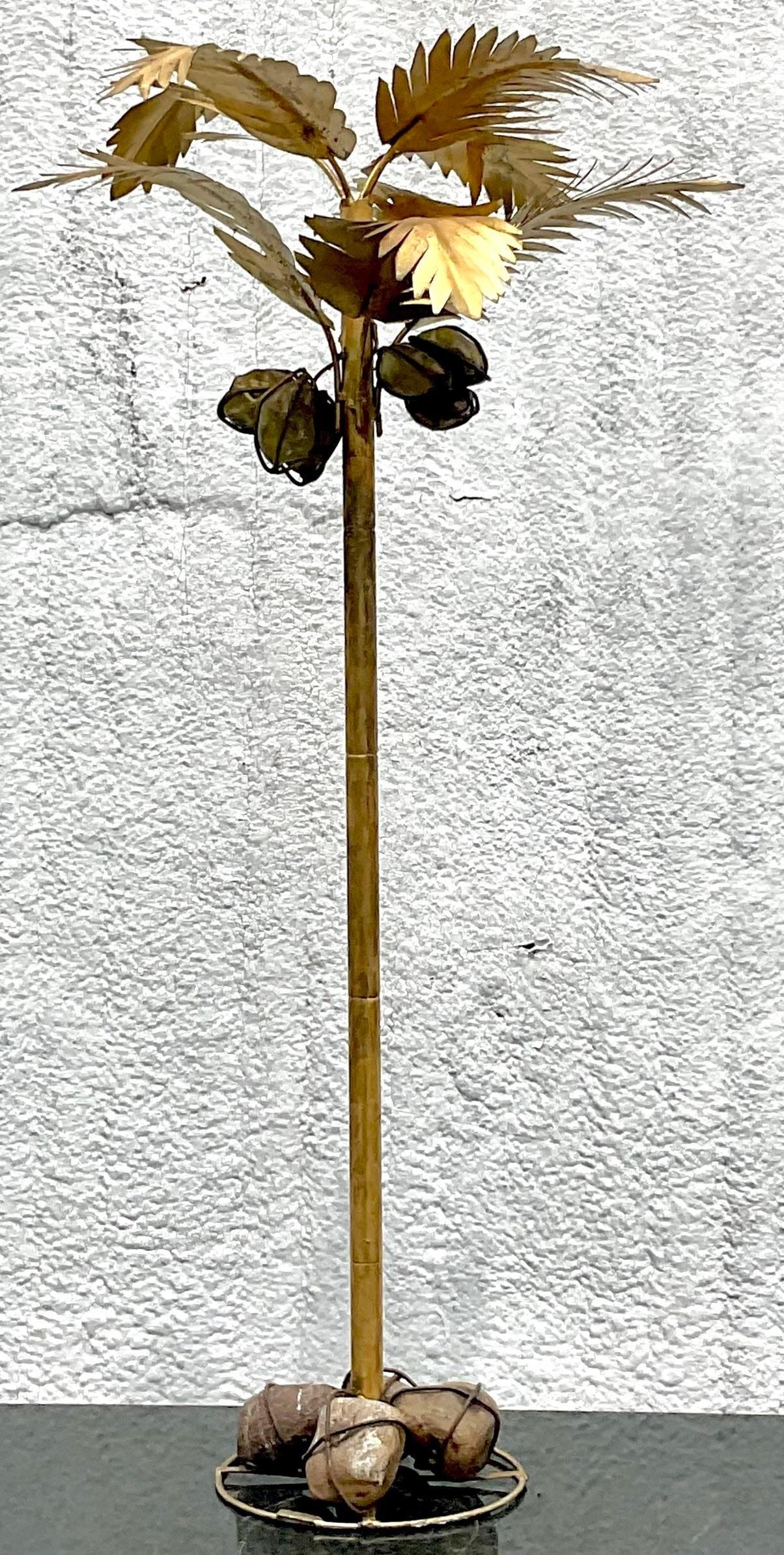 An extraordinary vintage Coastal standing palm tree. A chic gilt finish with wrapped and painted rocks as coconuts. Super glamorous and charming at the same time. Done in the manner of Maison Jansen. Acquired from a Palm Beach estate.