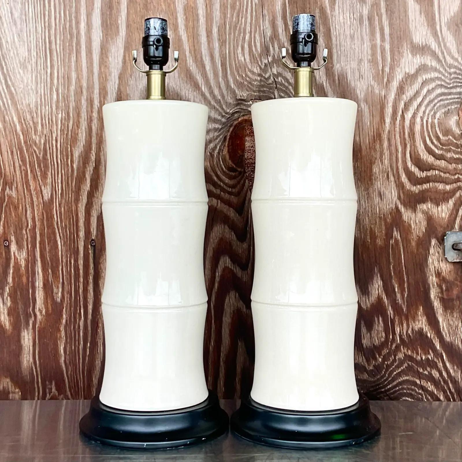 Fabulous pair of vintage Coastal table lamps. A beautiful ivory color in a glazed ceramic finish. Rest on embody plinths. Acquired from a palm Beach estate.
