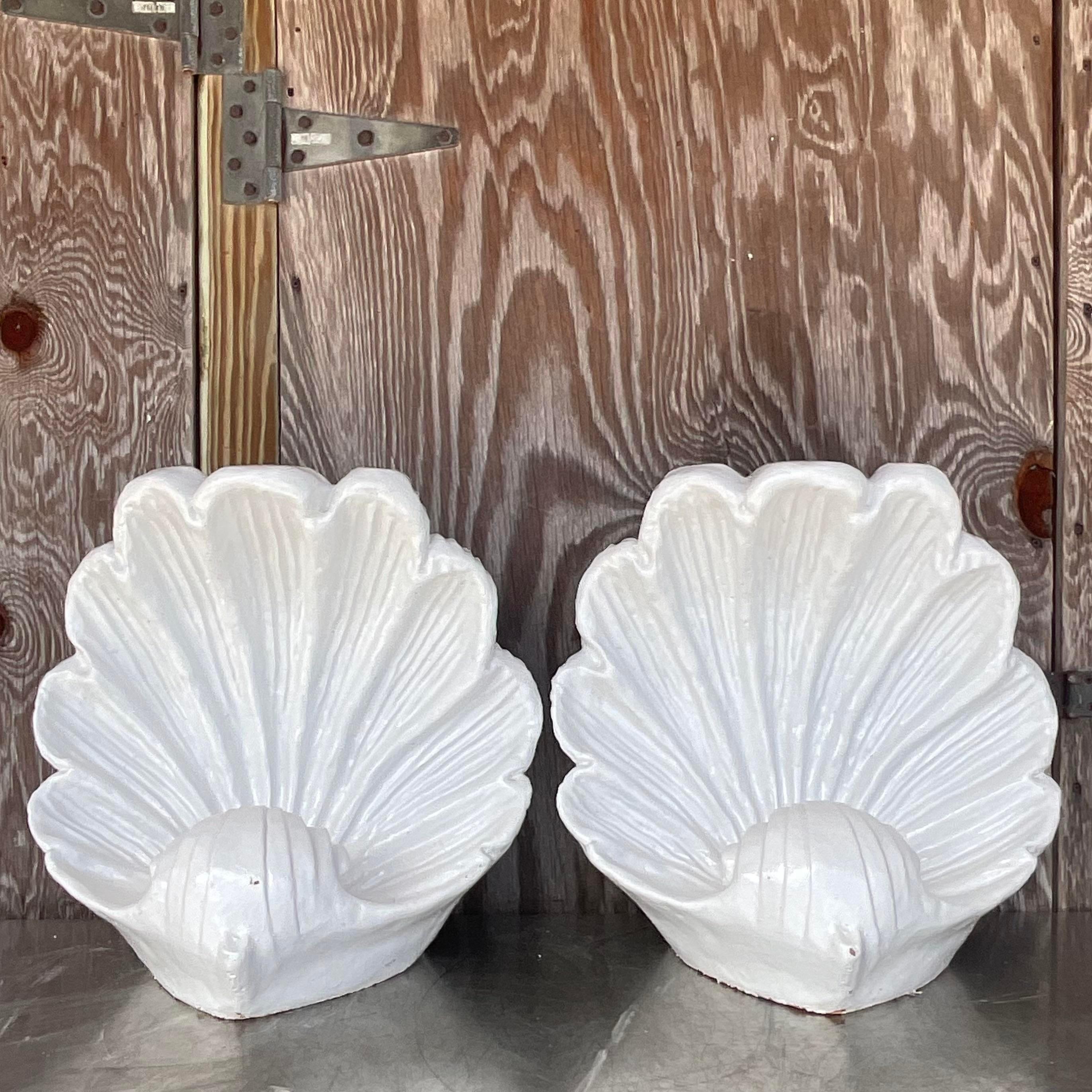 A fabulous pair of large vintage clam shells. A chic pair of ceramic shells in a glazed white finish. Can be used as a coffee table pedestal, but I think they look beautiful as a decorative element. Acquired from a Palm Beach estate