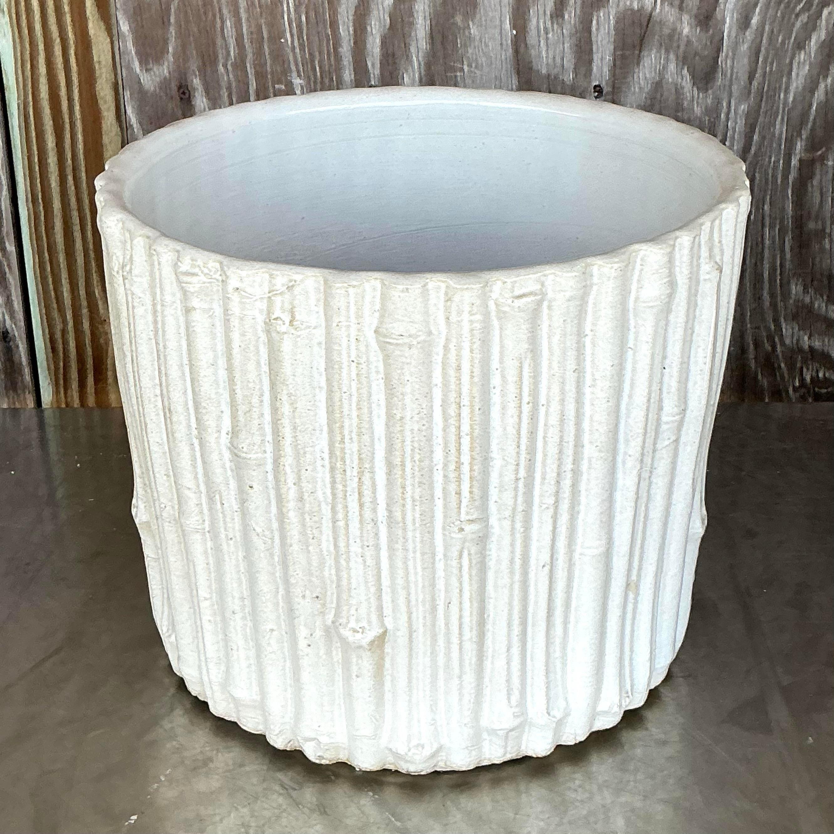 Elevate your decor with this Vintage Coastal Glazed Ceramic Faux Bamboo Planter. Featuring a stunning glazed finish and faux bamboo detailing, this planter beautifully combines natural coastal charm with a refined, tropical-inspired design. Its