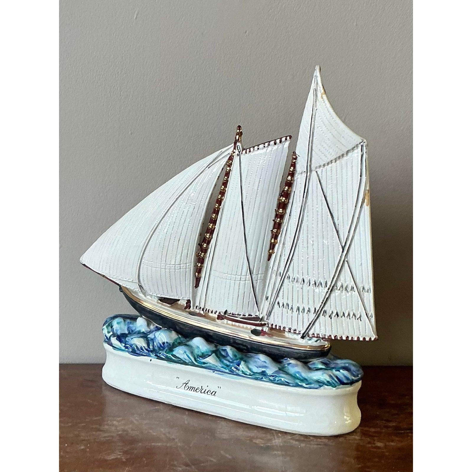 Capture the spirit of the sea with this exquisite vintage glazed ceramic sailboat decanter. A beautiful example of mid-century artistry, this piece is masterfully crafted, featuring intricately textured sails with rich brown piping that rise above a