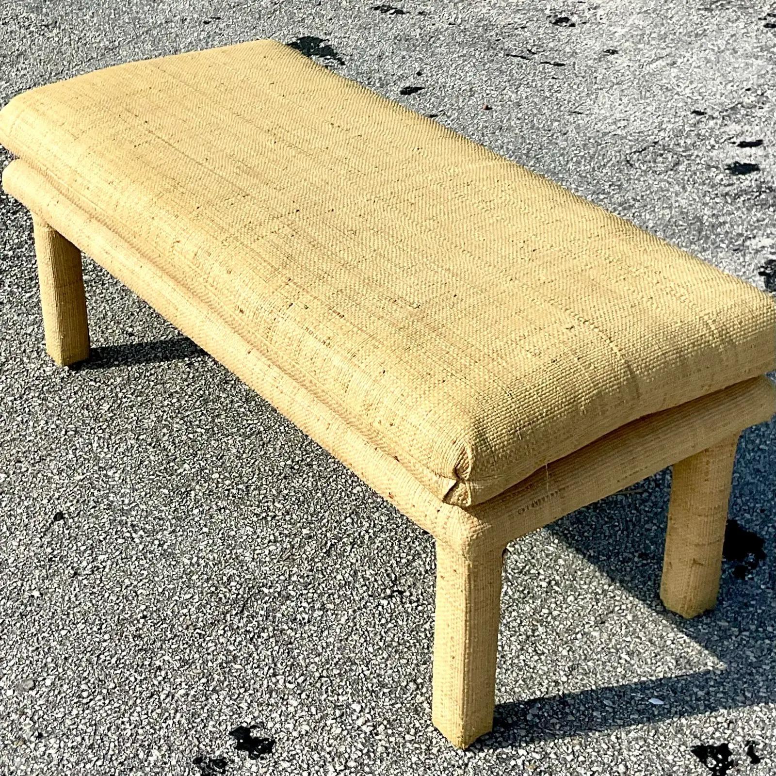 A fantastic vintage Coastal bench. Upholstered in the chicest Grasscloth with a clean shape. Acquired from a Palm Beach estate.