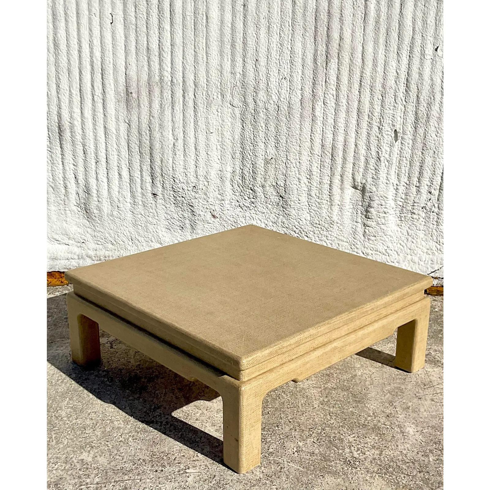 A fantastic vintage Coastal coffee table. A custom built beauty with a chic Grasscloth finish. Notched Parsons shape in a pale gold color. Perfect as is or paint to coordinate with your room. Acquired from a Palm Beach estate.