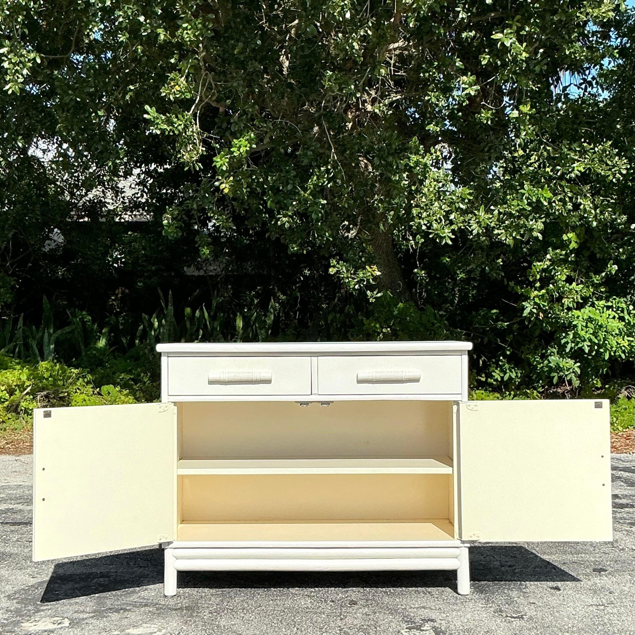 A chic little vintage Coastal sideboard. A painted cabinet with inset seagrass doors. Lots of great storage below. Acquired from a Palm Beach estate.
