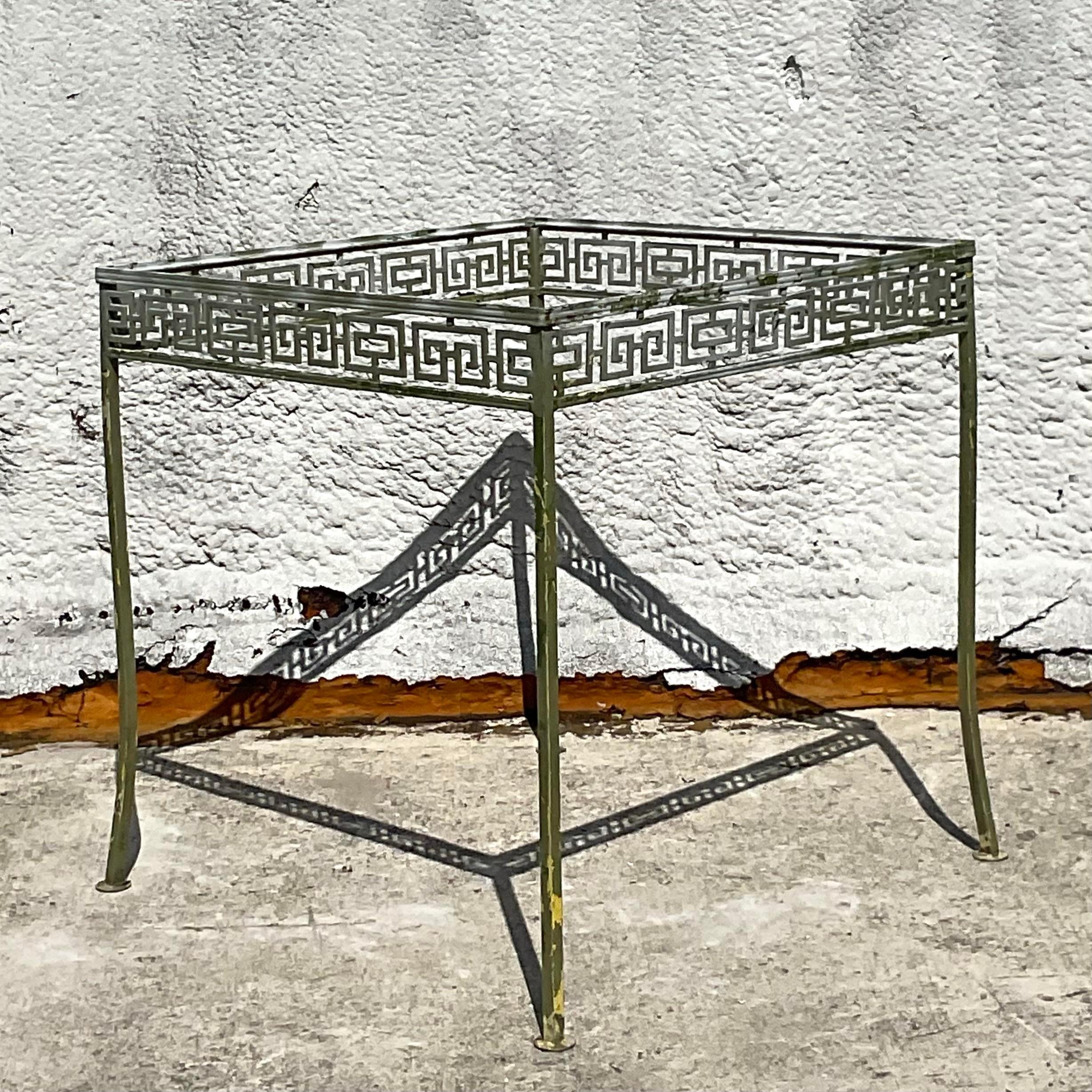 Elevate your dining experience with this Vintage Coastal Greek Key Wrought Iron Dining Set of 5, blending coastal charm with American craftsmanship. Crafted with enduring wrought iron and adorned with iconic Greek Key motifs, it's a fusion of style