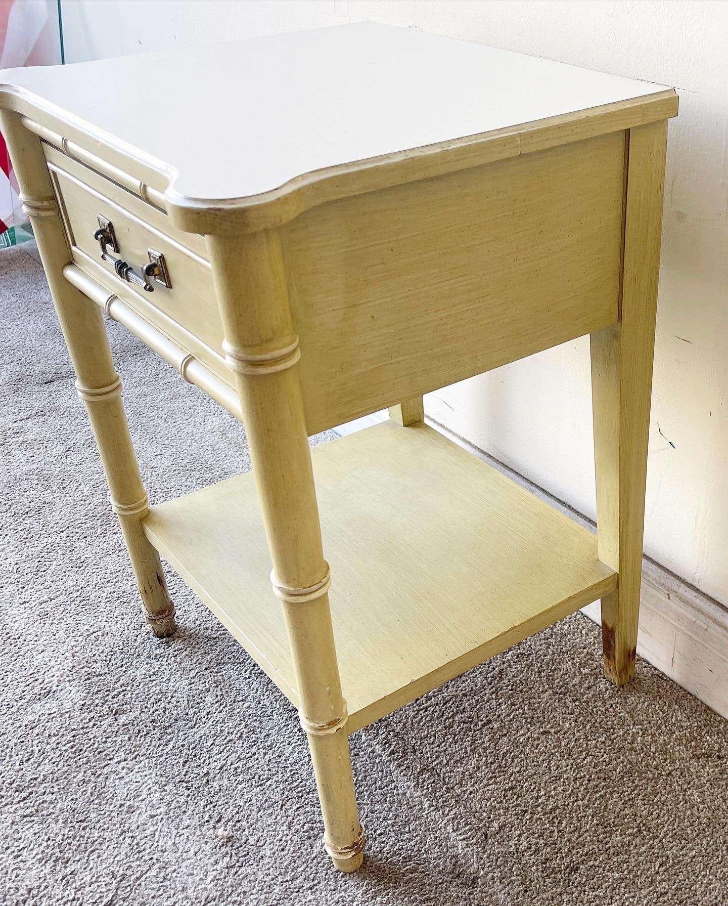 Amazing vintage coastal side/end table/nightstand. Feature a light green finish over a faux bamboo frame with a white laminate top.