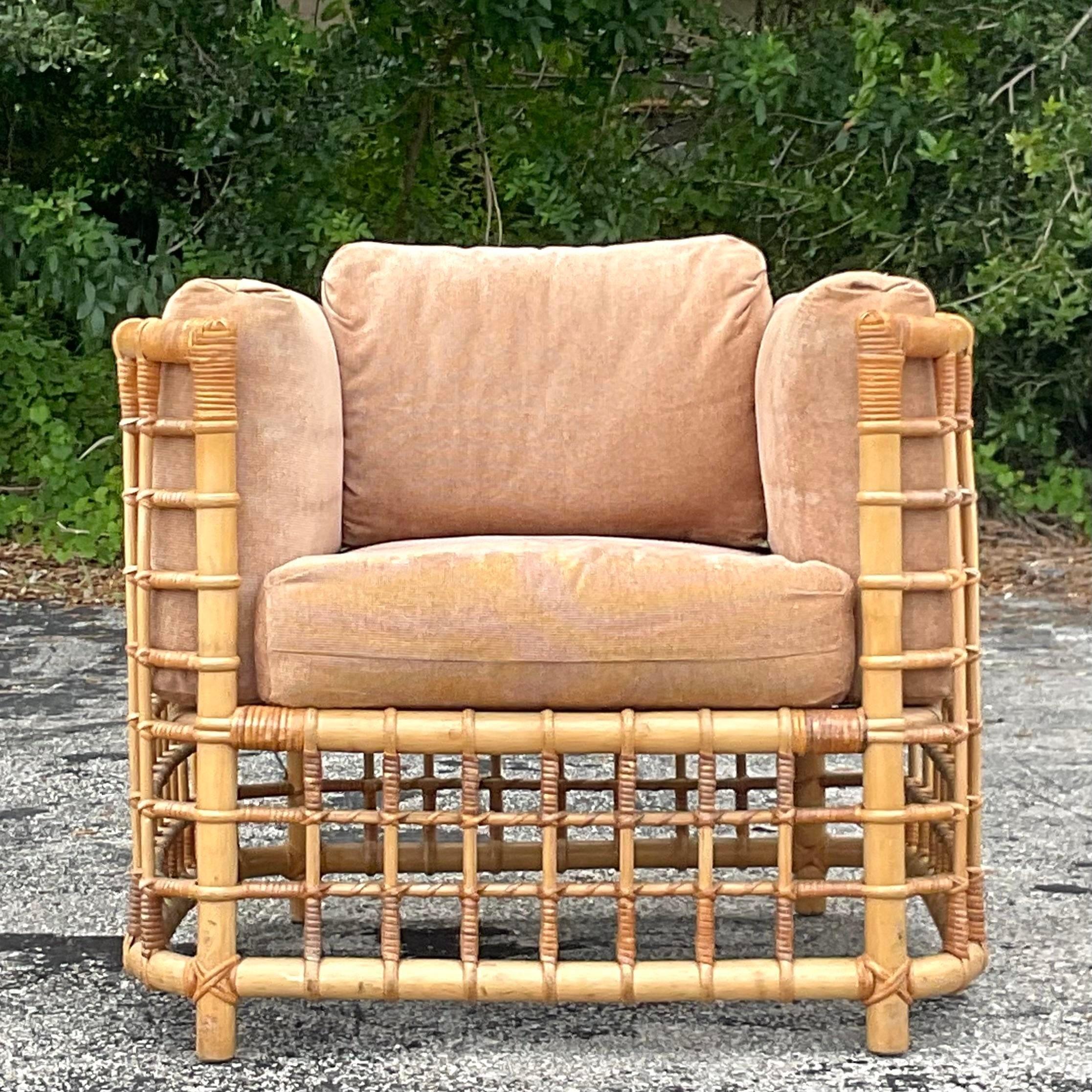 An exceptional vintage Coastal lounge chair. A chic rattan frame in a grid design. Done in the manner of Henry Olko. Acquired from a Palm Beach estate.