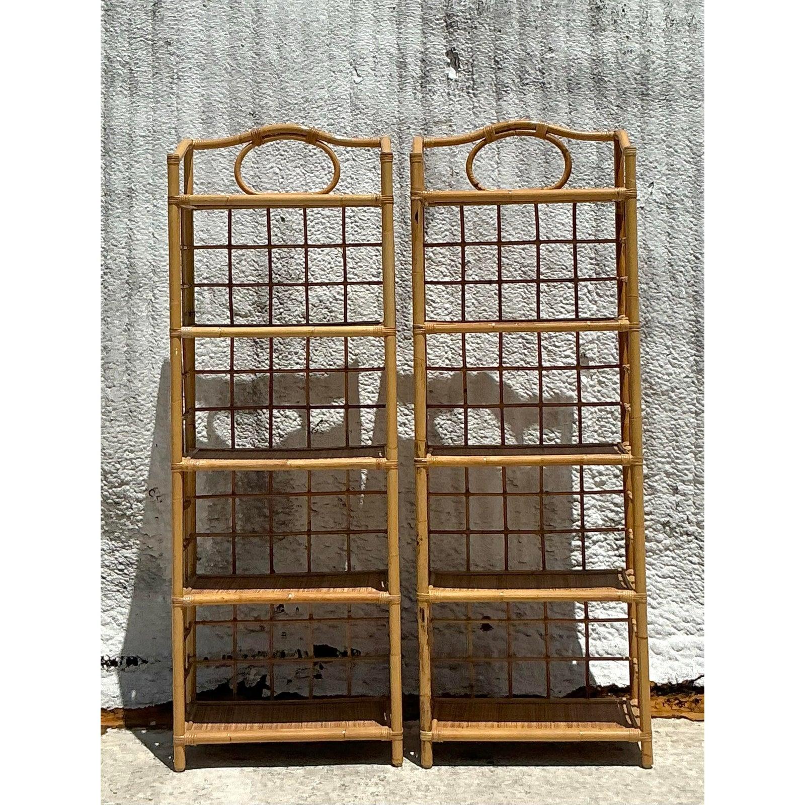 Invite breezy, coastal charm into your home with this delightful pair of vintage rattan and bamboo étagères. Expertly crafted from natural materials, these shelving units feature an airy, open-weave design with multiple tiers, perfect for showcasing