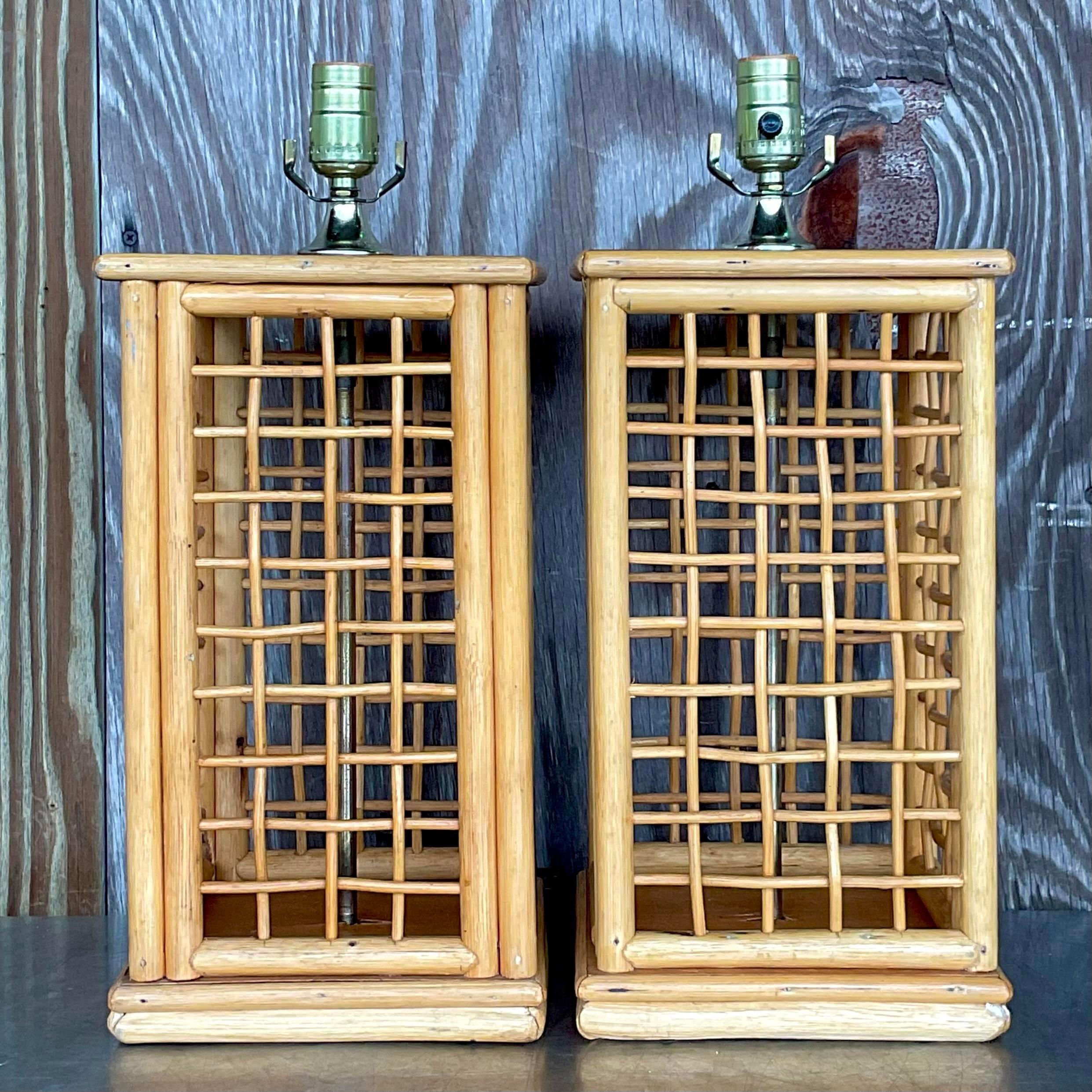 A fabulous pair of vintage Coastal table lamps. Chic grid rattan in a solid rattan frame. Acquired from a Palm Beach estate.