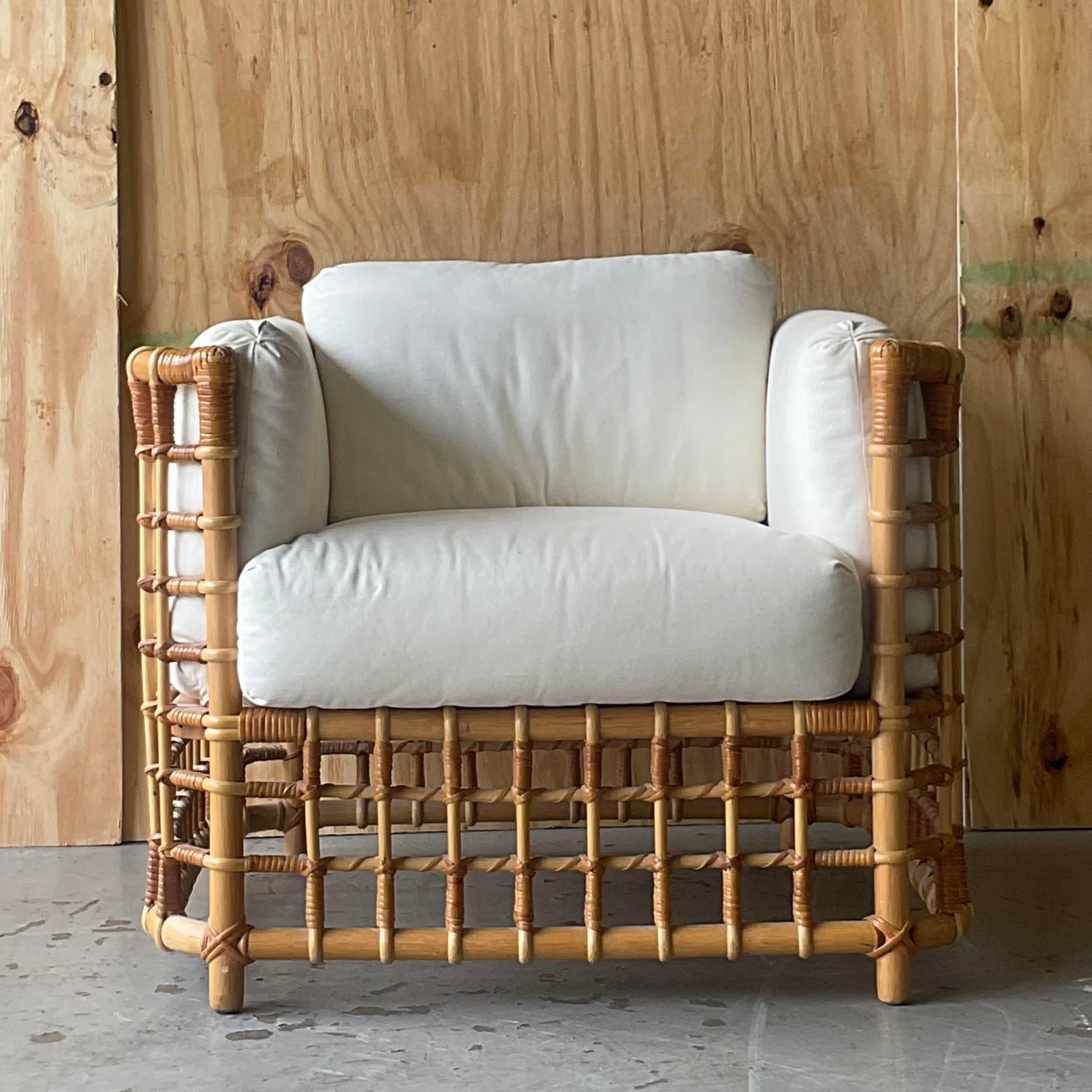 A fabulous vintage coastal lounge chair. A chic bent rattan in a grid design. Done in the manner of Henry Olko for Willow and Reed. Acquired from a Palm Beach estate. 