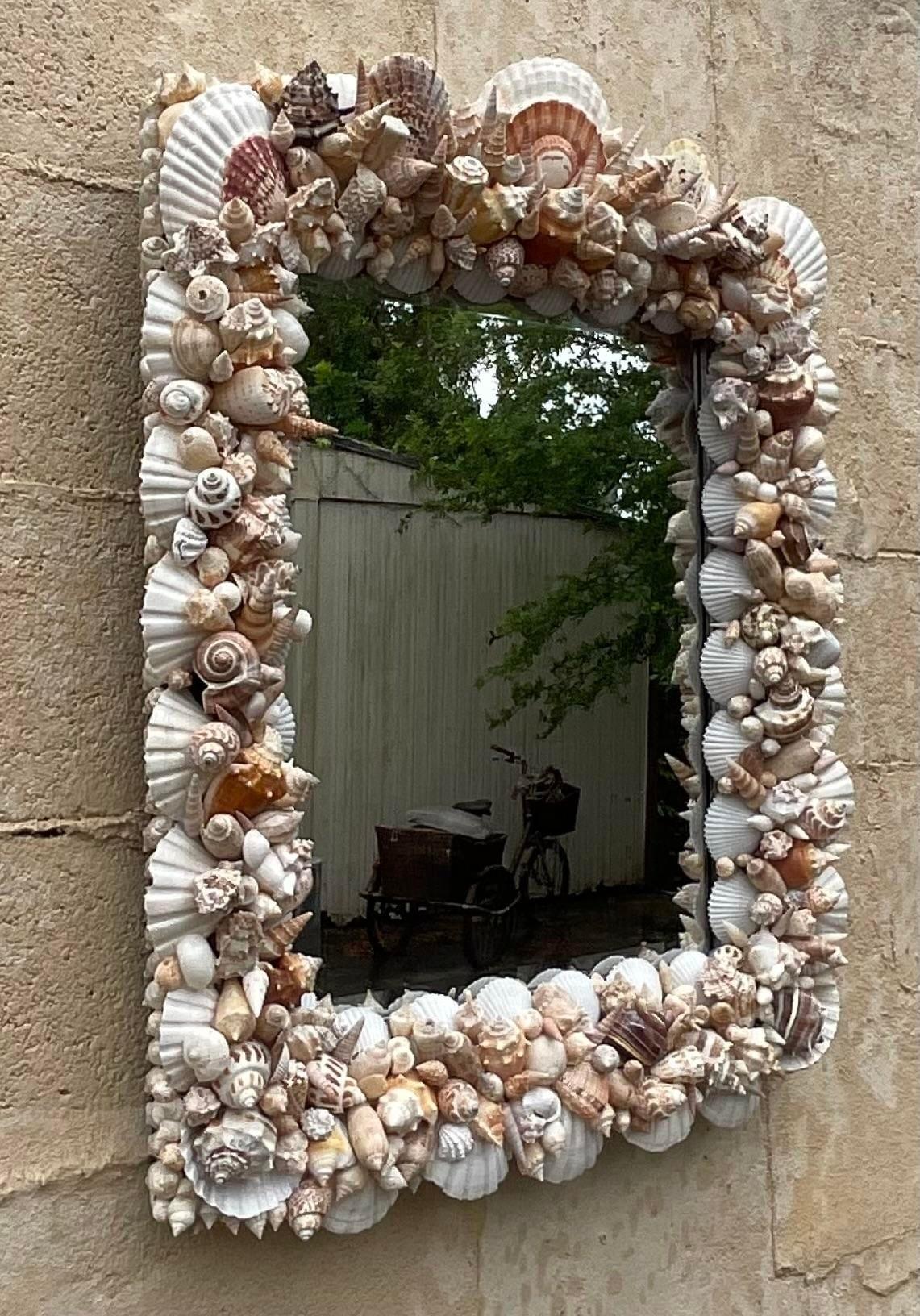 Transform your space with a touch of seaside charm with our Vintage Coastal Handmade Shell Mirror. Crafted with care and attention to detail, this exquisite piece reflects the laid-back elegance of American coastal living. Each shell intricately