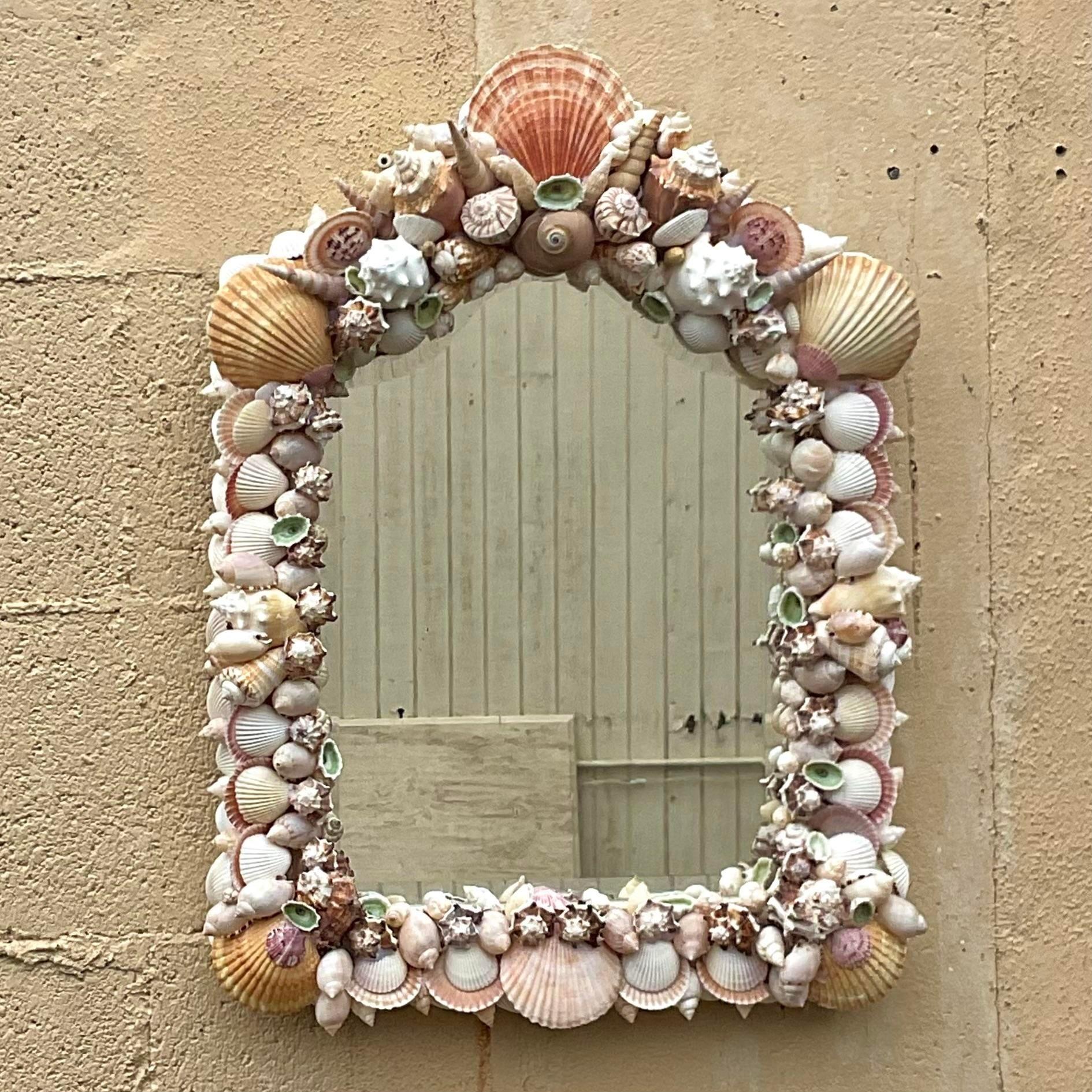 Embrace the timeless allure of coastal living with our Vintage Coastal Handmade Shell Mirror. Handcrafted with care, each shell delicately placed to evoke the spirit of American seaside charm. Reflecting both craftsmanship and coastal beauty, this