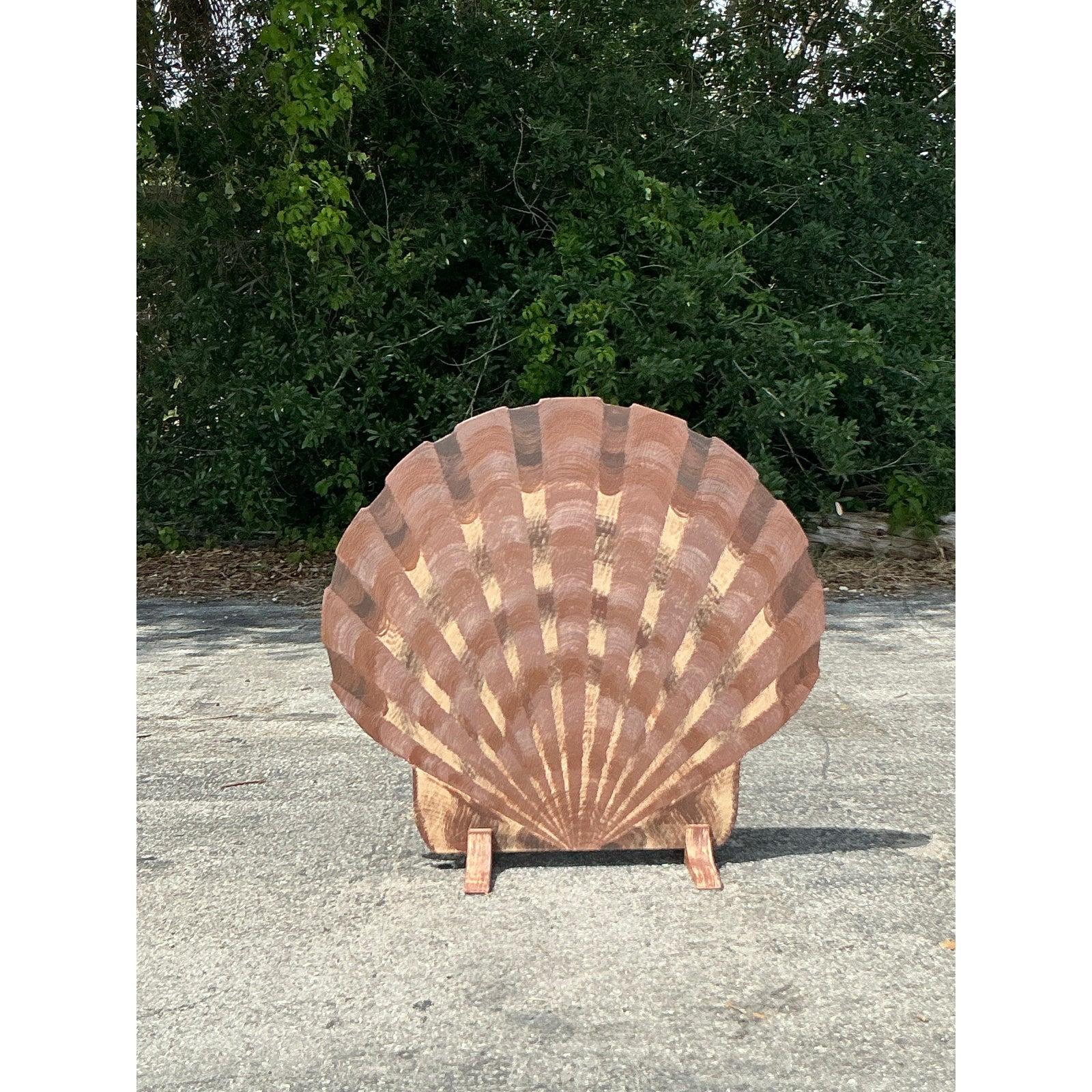 Make a bold, beachy statement with this charming vintage coastal shell screen, hand-painted to mimic the natural beauty of a scallop shell. Crafted from sturdy wood and finished in earthy tones of sun-washed brown and sand, the piece offers an