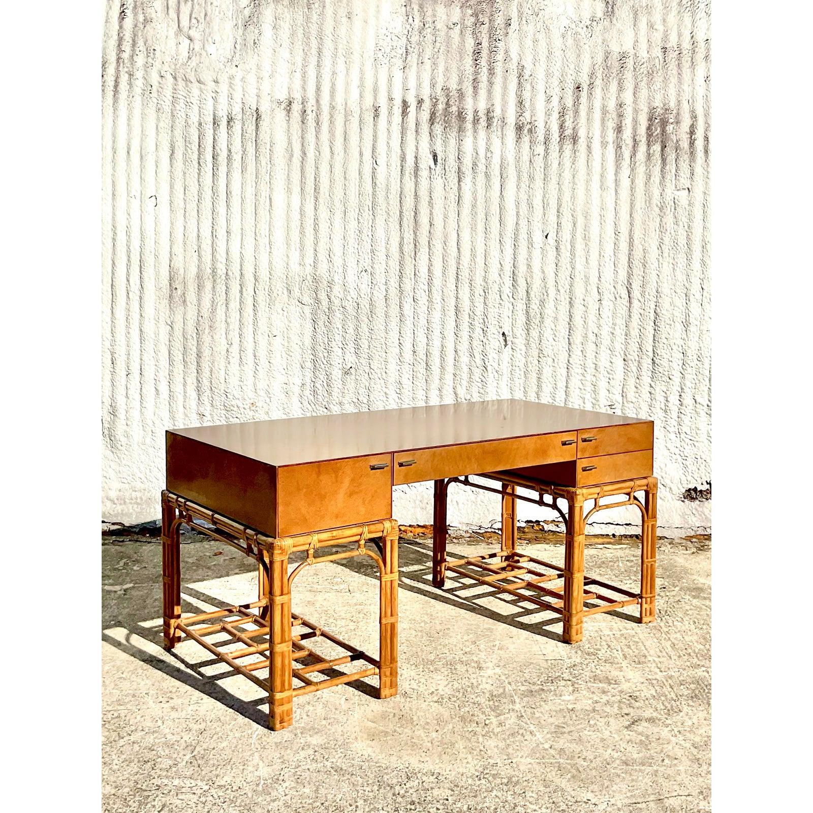 Stunning vintage Coastal executive desk. Made by the iconic Henredon company. Part of their coveted Circa East collection. Beautiful Birdseye Maple top in a Campaign design that rests on a chic rattan frame. Nickel hardware and rawhide wraps.